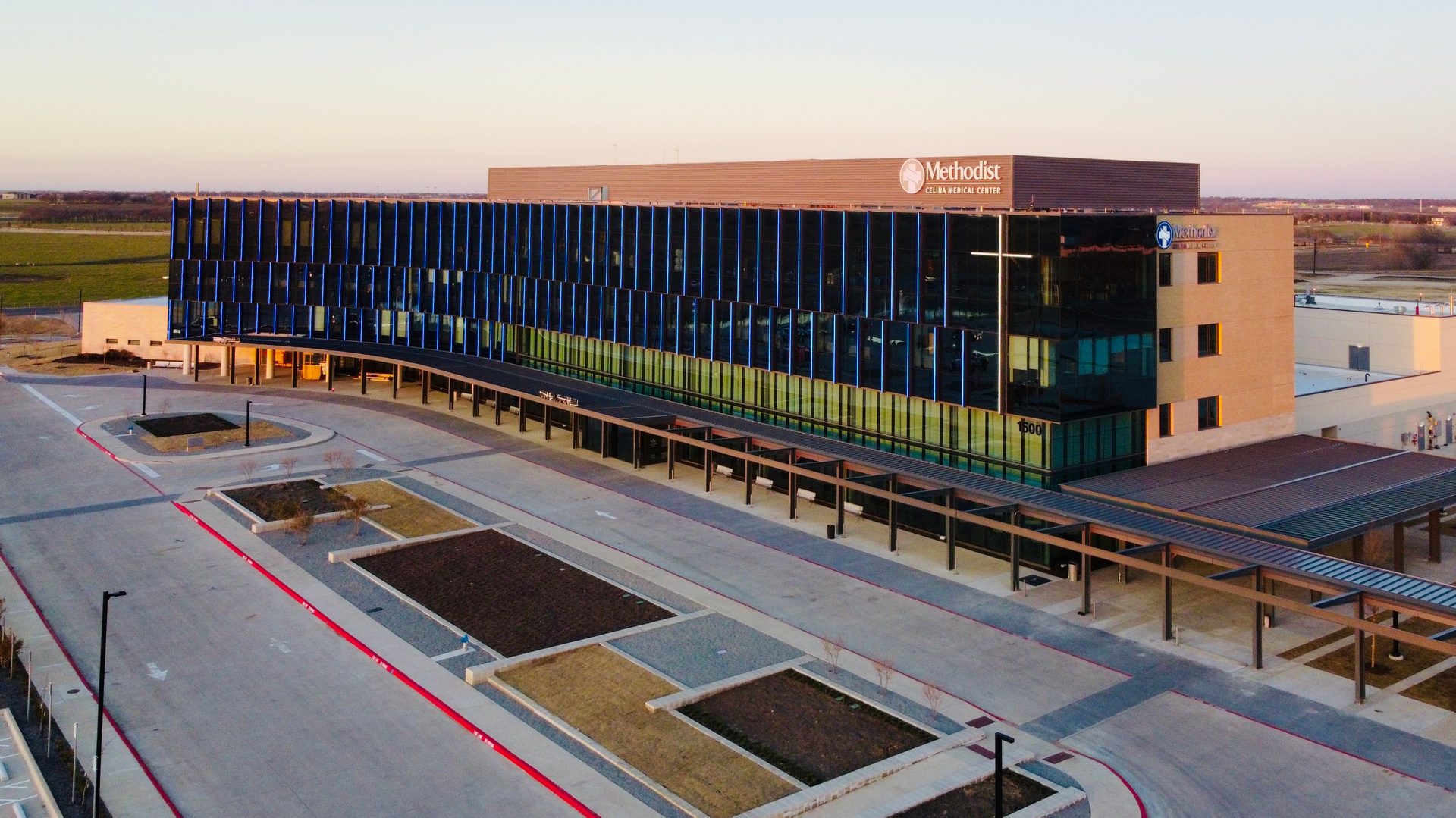 Aerial view of Methodist Celina Medical Center, a modern hospital building at sunset.