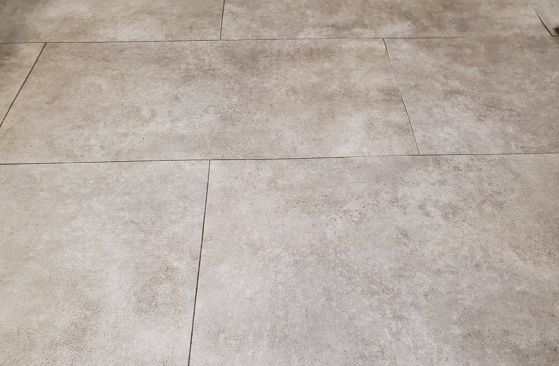 Textured light brown floor tiles.