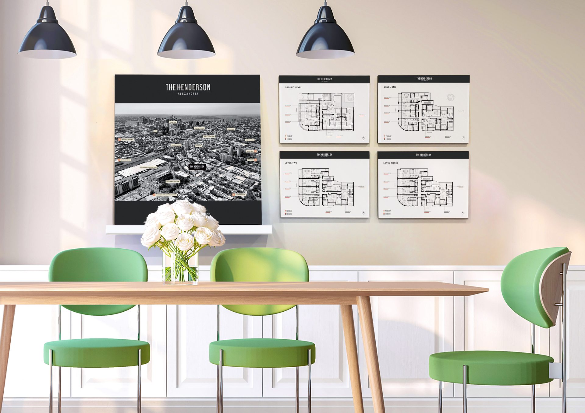 Modern dining room with green chairs, an aerial map of "The Henderson", and four floor plans on the wall.
