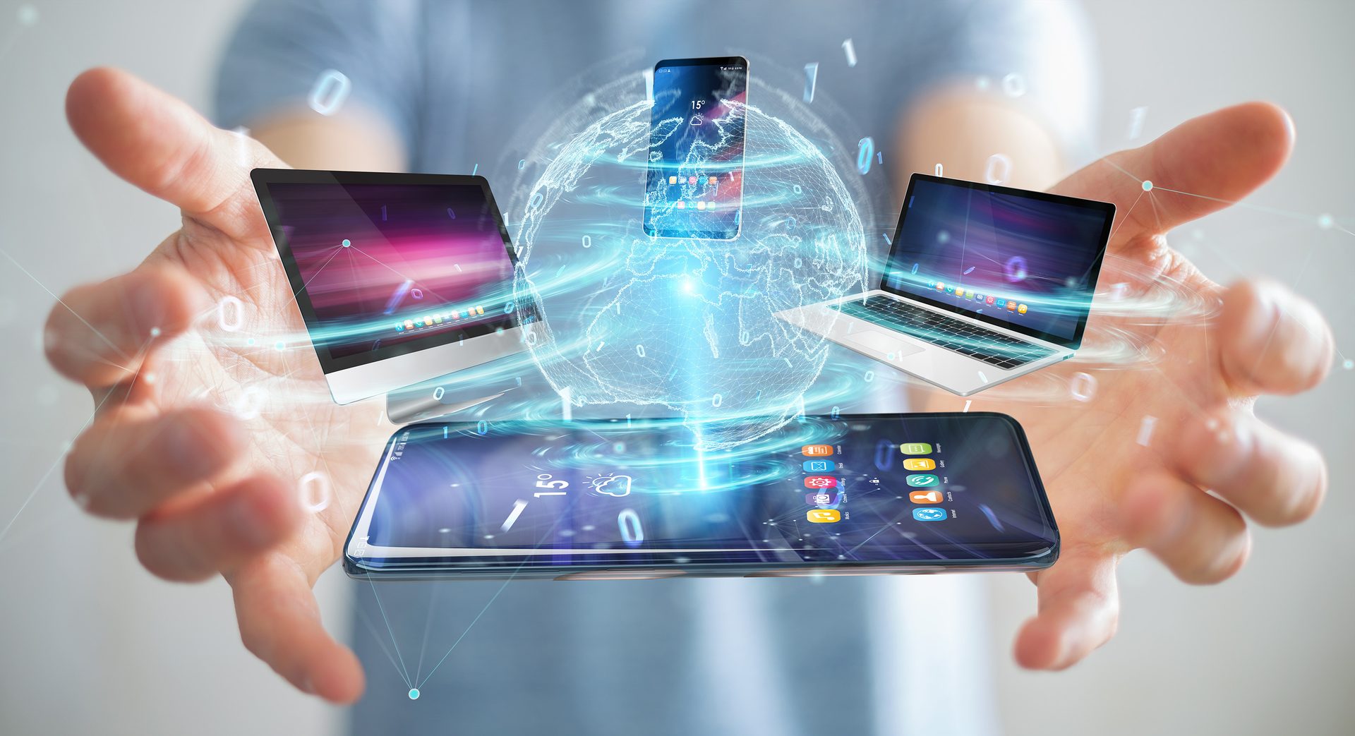 Hands holding digital devices (phone, tablet, laptop) interconnected by a glowing global network.