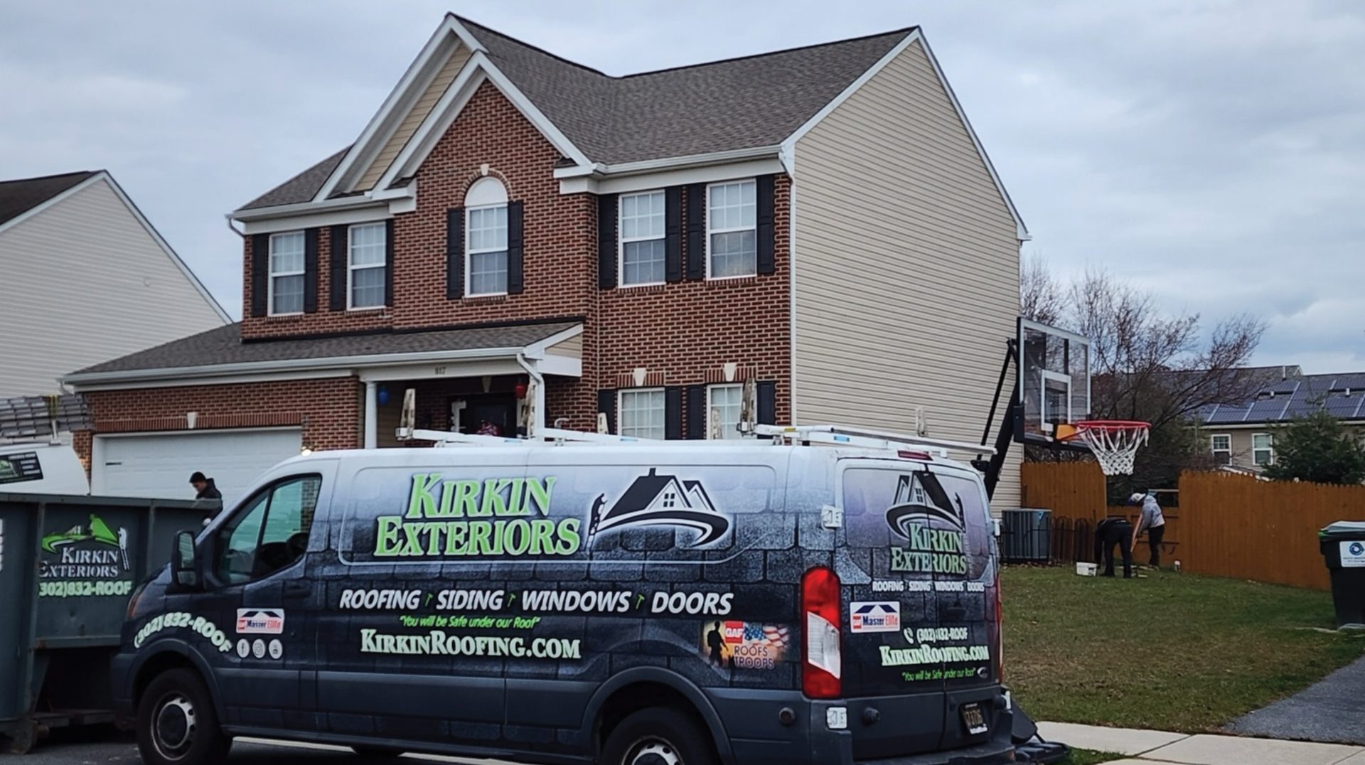 Kirkin Exteriors van and dumpster at a house with a new roof.