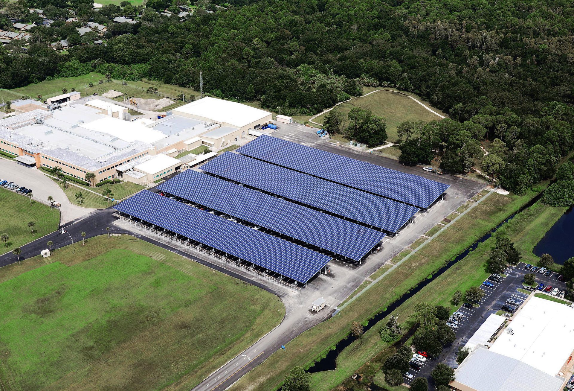 Land lot, Urban design, Solar panel, Residential area, Plant, Slope, House, Grass, Building