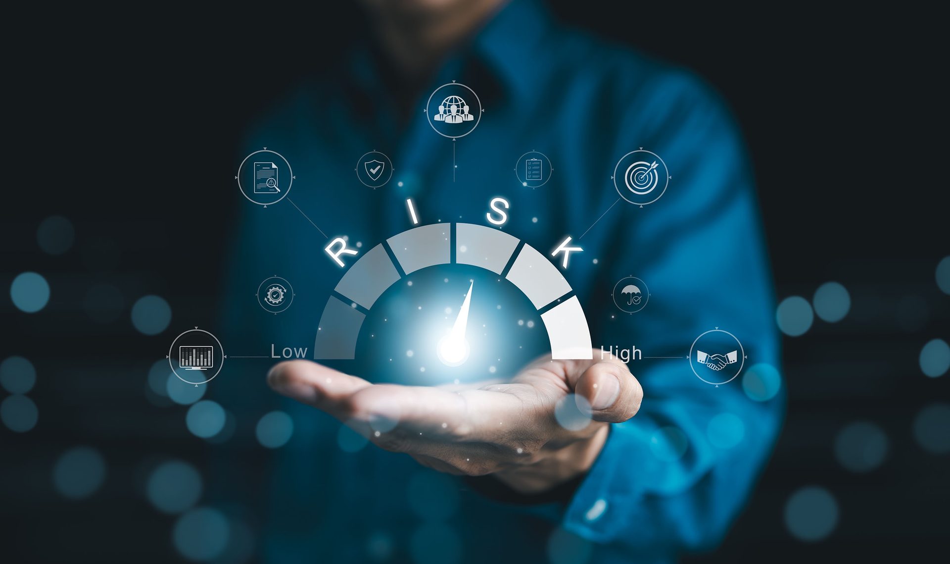 Hand holding a glowing risk meter (low to high) at a moderate level, surrounded by business icons.