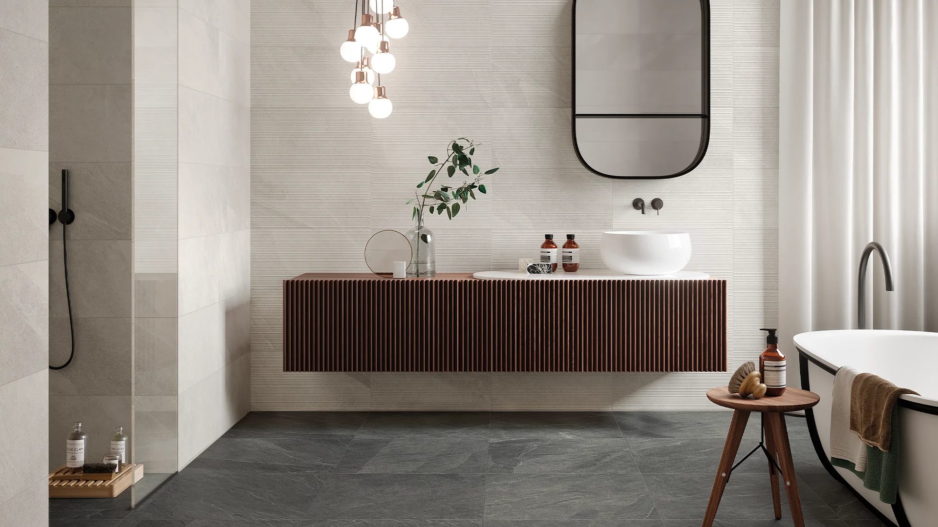 Sleek bathroom: dark floor, textured walls, wood vanity, white basin, mirror, shower, freestanding tub.