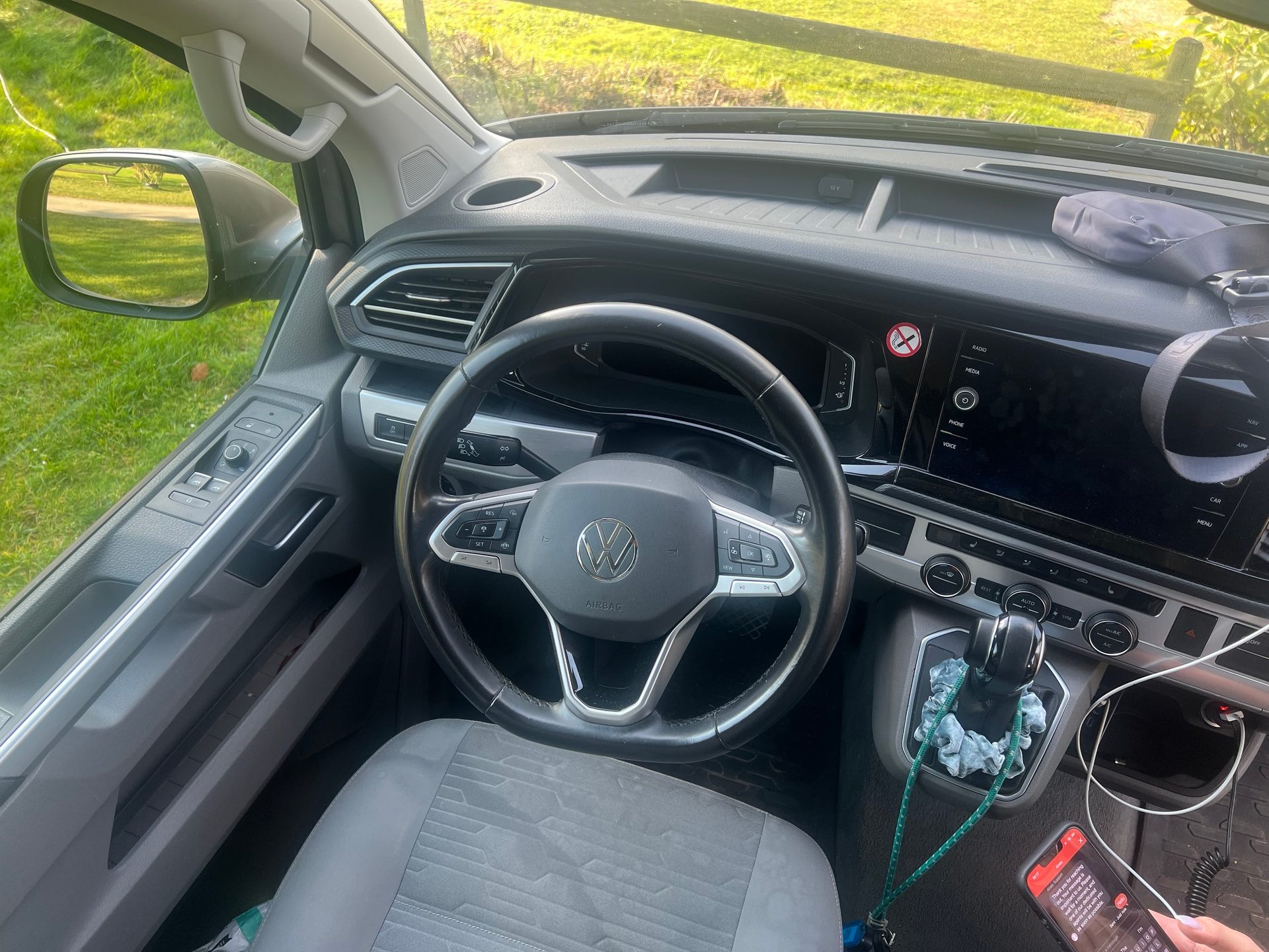 Driver's perspective inside a modern Volkswagen car, showing the steering wheel, dashboard, and center console.