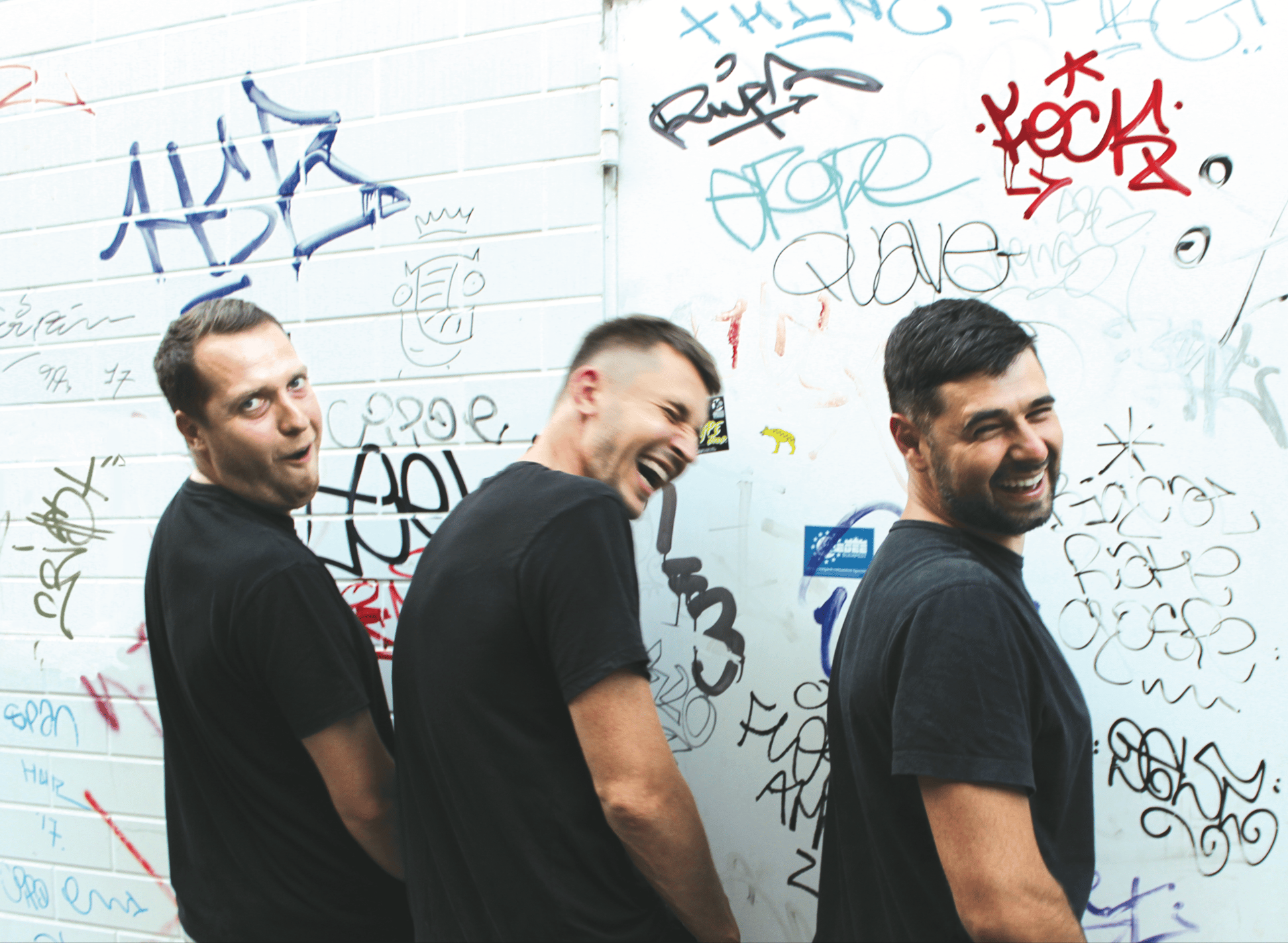 Social group, Forehead, Smile, Handwriting, Gesture, Font, Wall, T-shirt