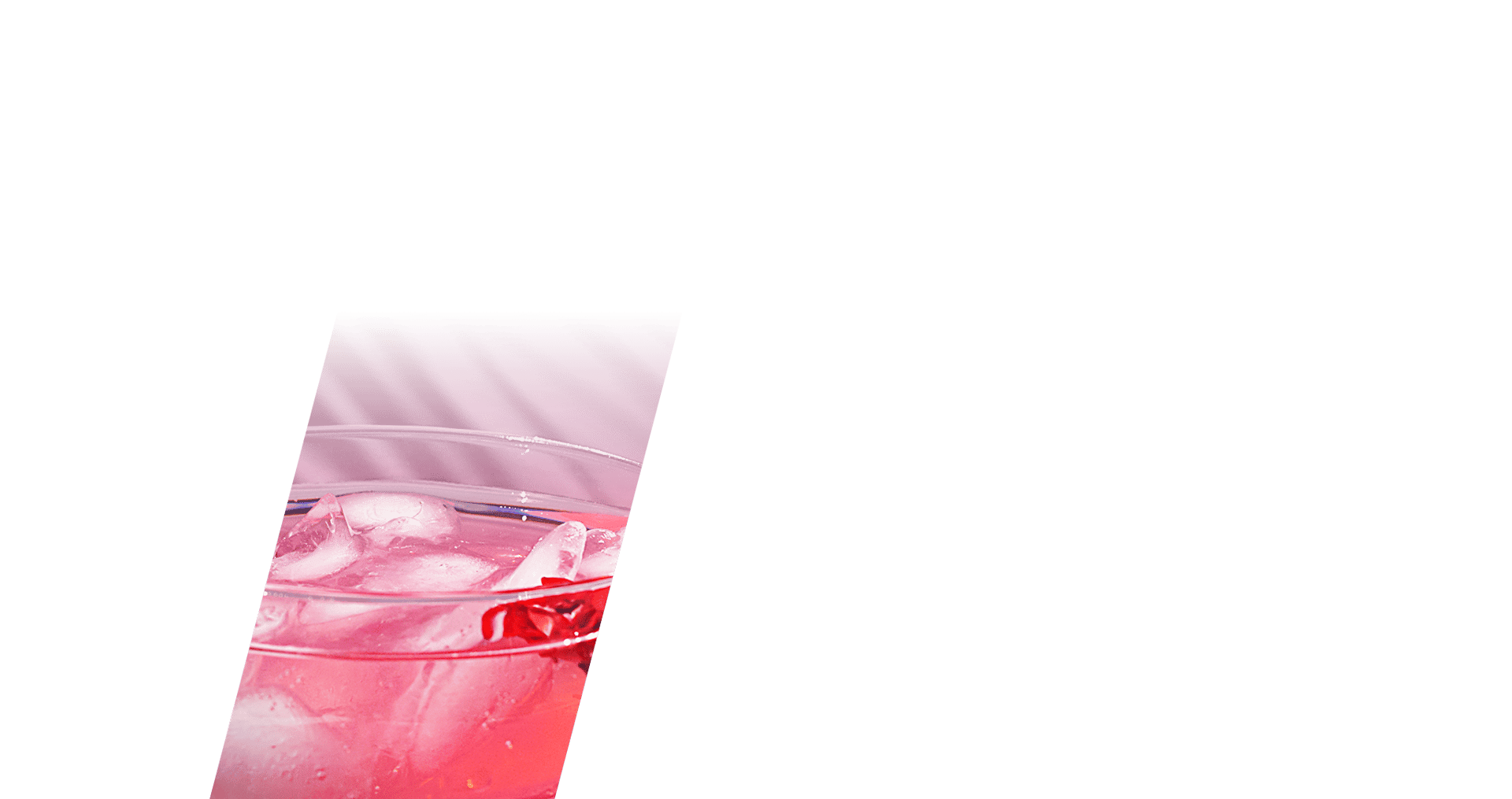 Vibrant pink drink with ice in a clear glass, partially visible against a green background with subtle shadows.
