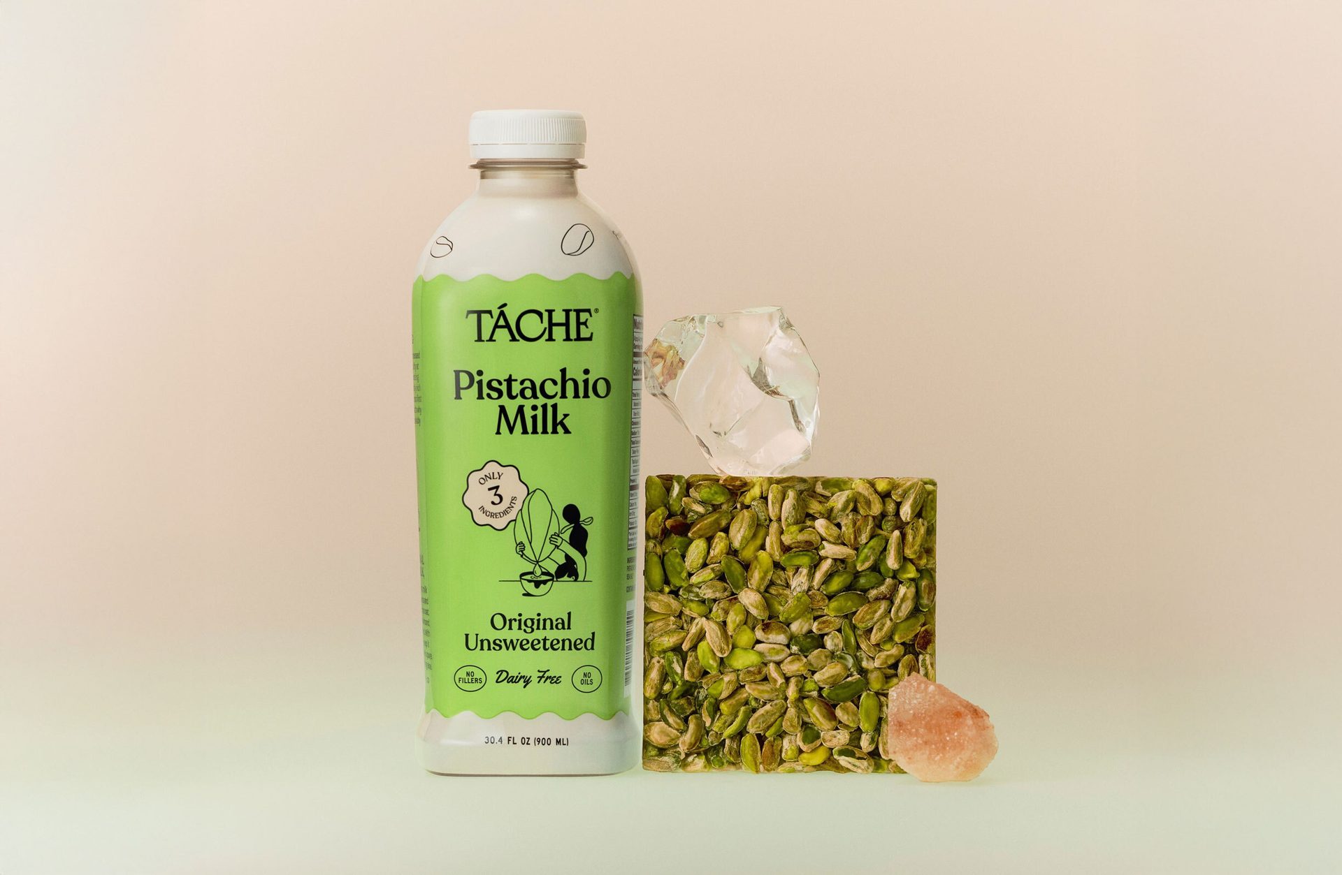 Tache Pistachio Milk bottle, pistachio block, ice, and pink rock.