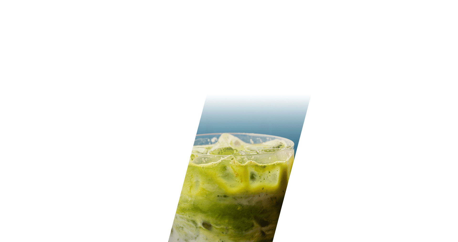 Iced matcha latte in a clear glass, with distinct green matcha and white milk layers.