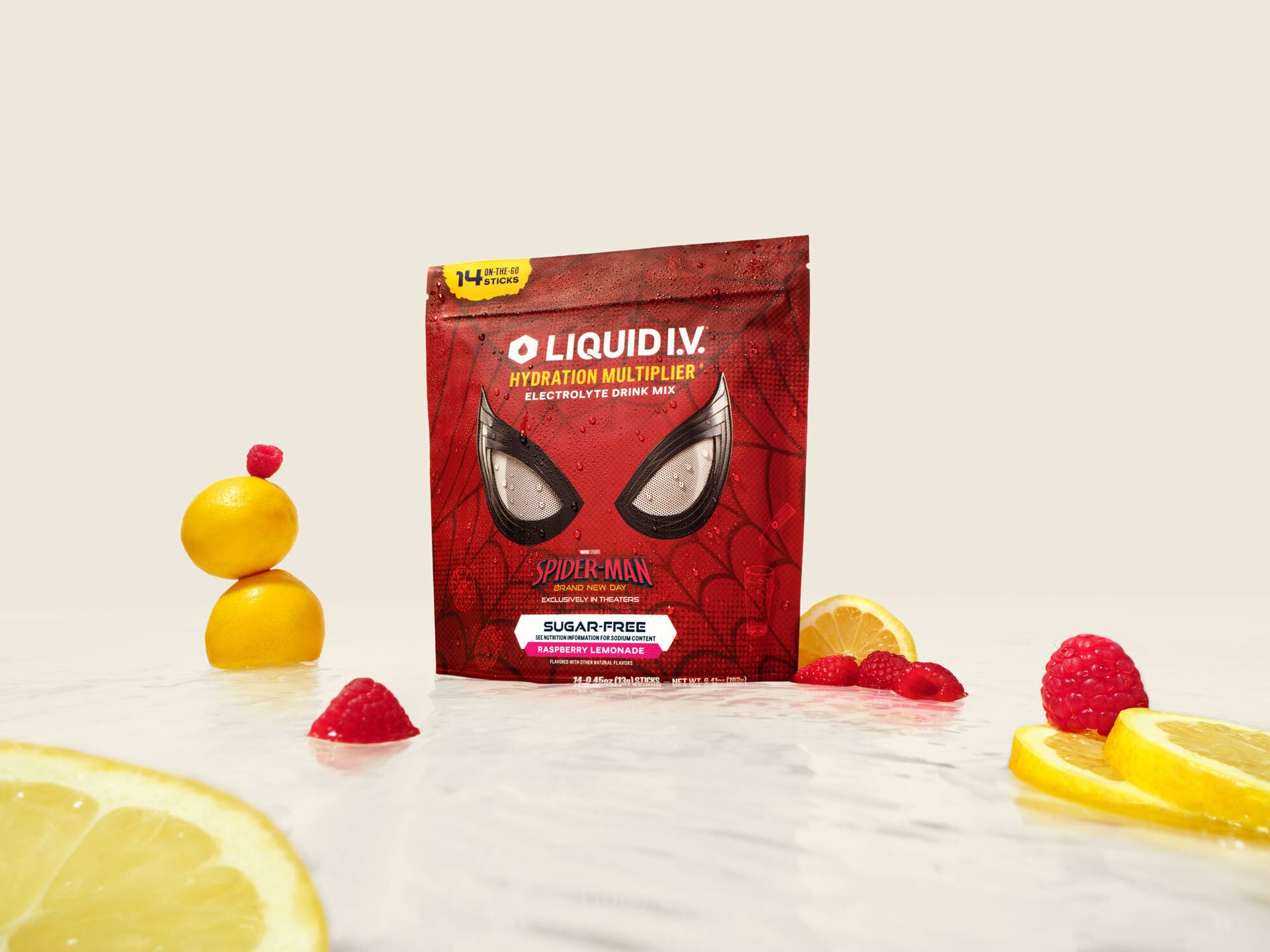 Liquid I.V. Hydration Multiplier Spider-Man Raspberry Lemonade pouch with fresh lemons and raspberries.