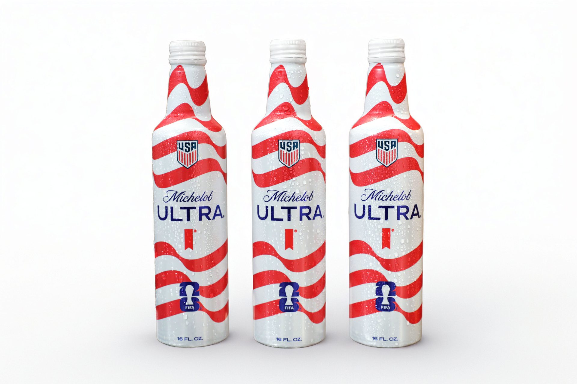 Three Michelob Ultra beer bottles with a USA flag design and FIFA branding, standing upright.