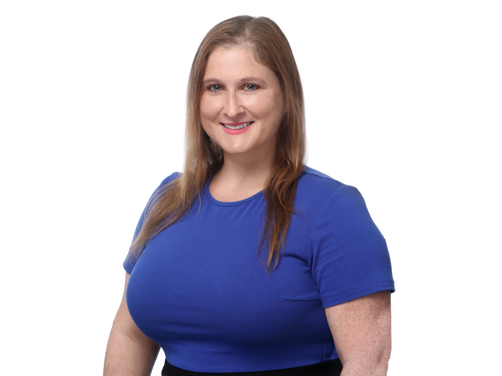 Smiling woman with long brown hair, wearing a blue shirt and black skirt, against a white background.