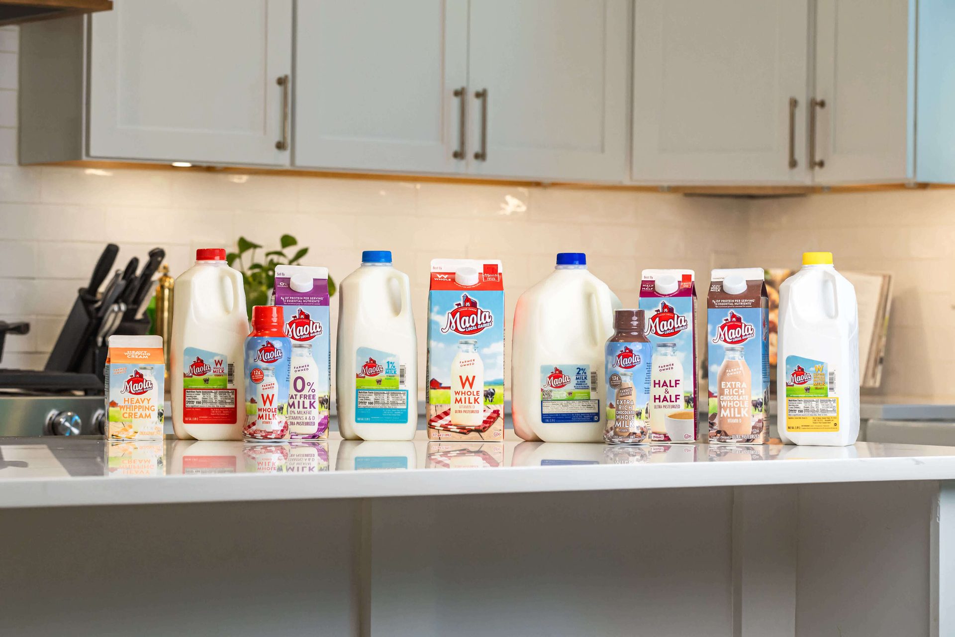 Assortment of Maola milk and dairy products on a kitchen counter.
