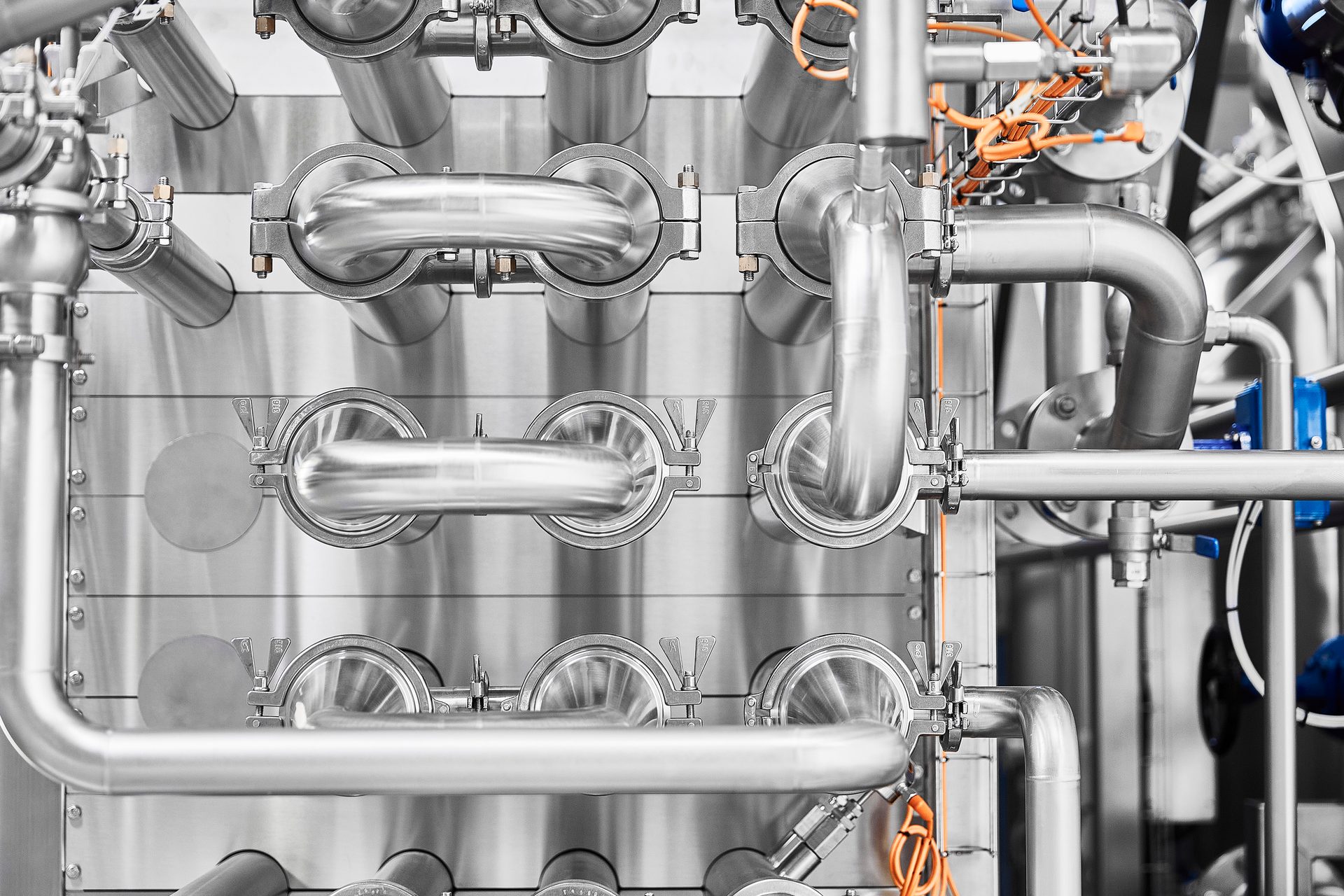 Industrial stainless steel processing equipment, pipes, and valves.
