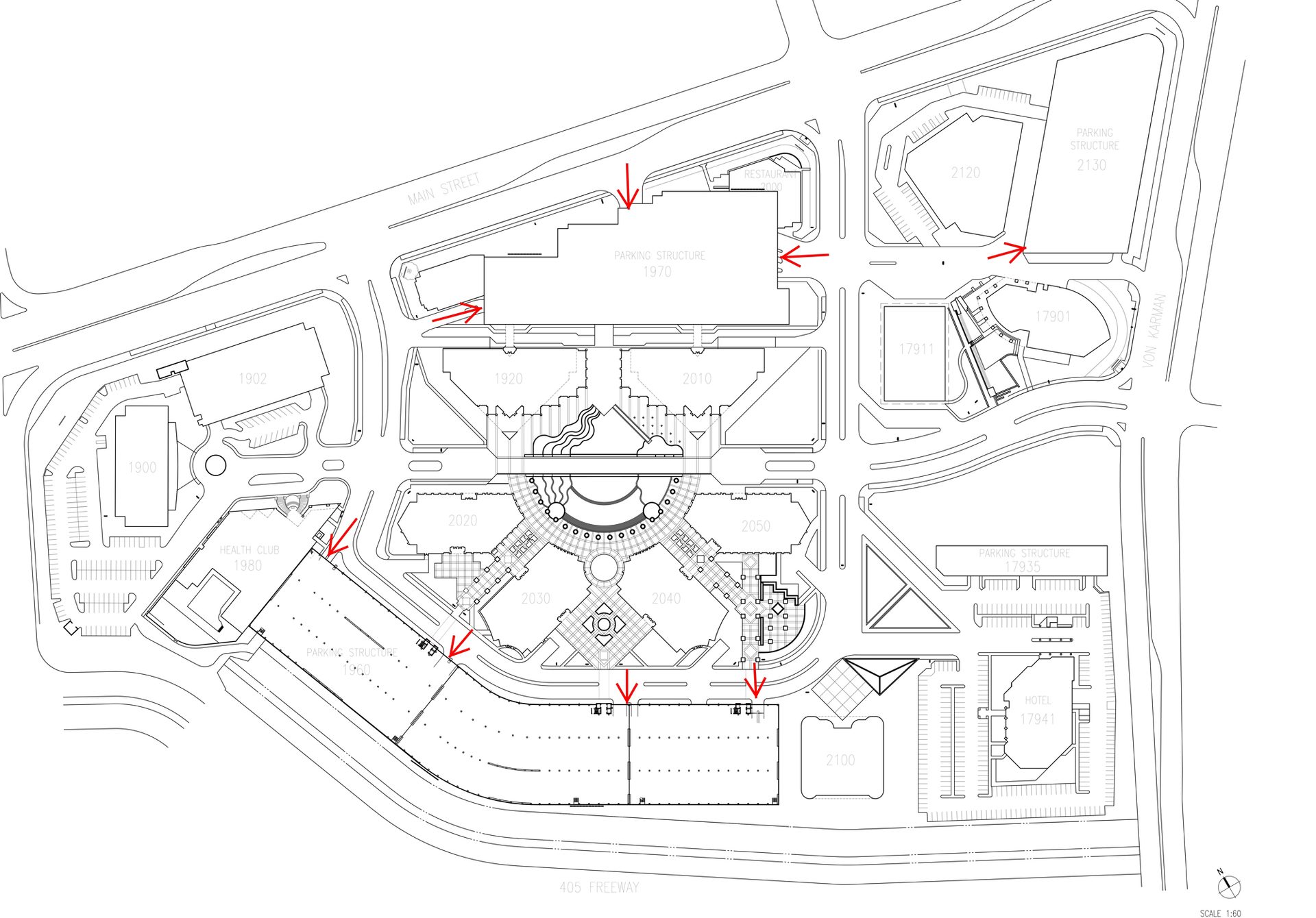 Architectural site plan with buildings, parking, roads, and red arrows indicating entry points.