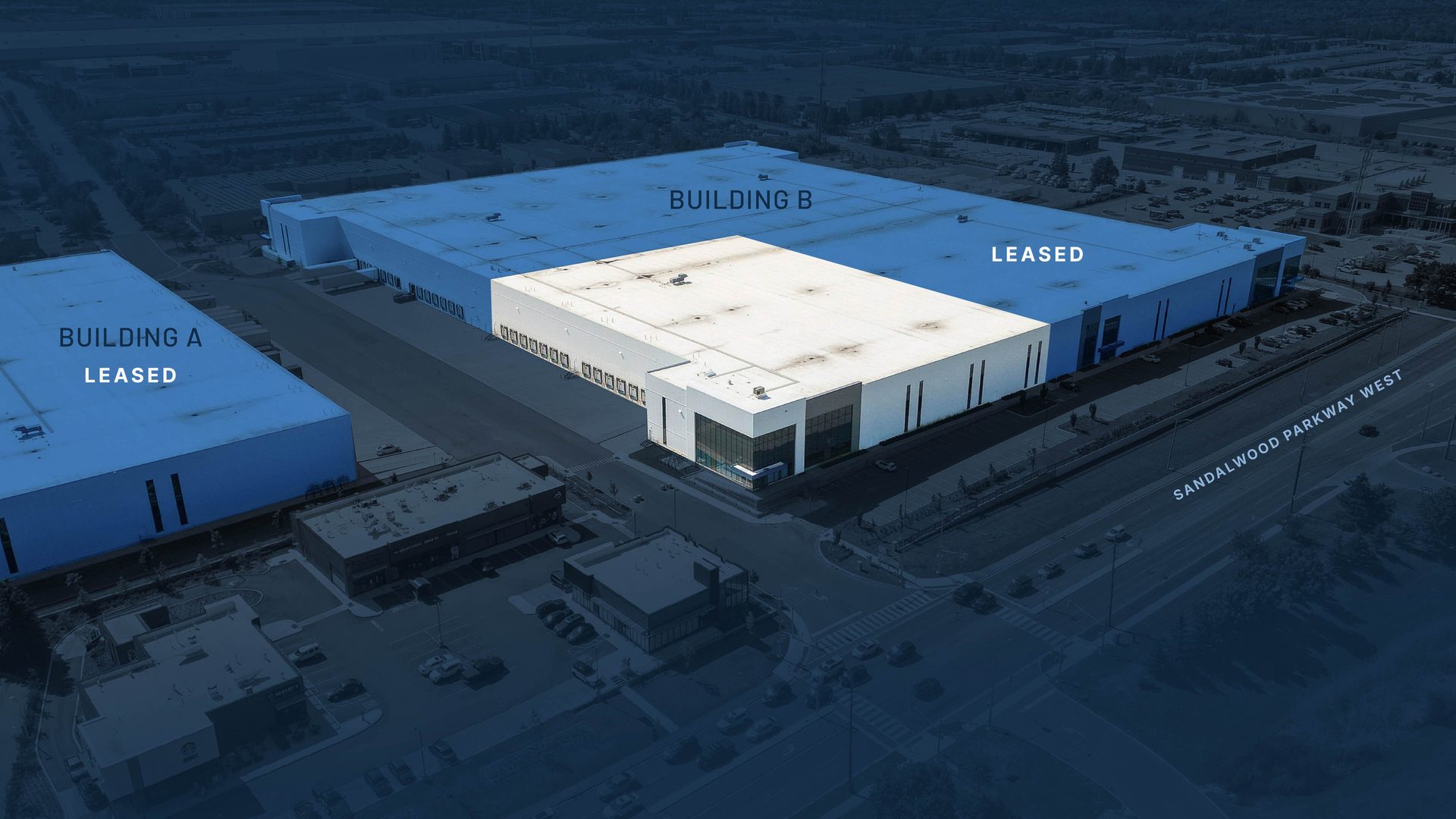Overhead view of two industrial buildings, "Building A Leased" and "Building B" with an available section.