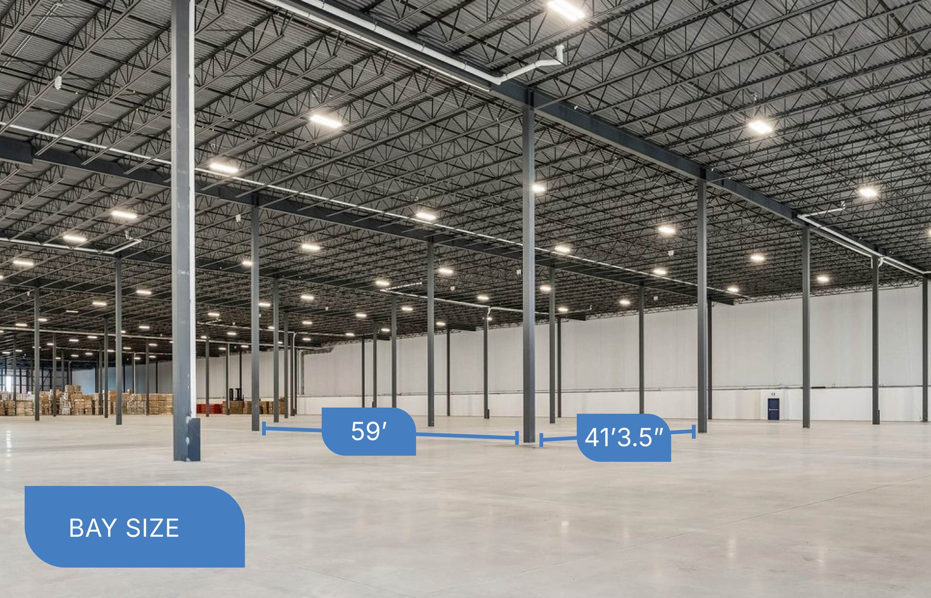 Empty warehouse interior showing high ceiling, concrete floor, and bay size measurements: 59', 41'3.5''.