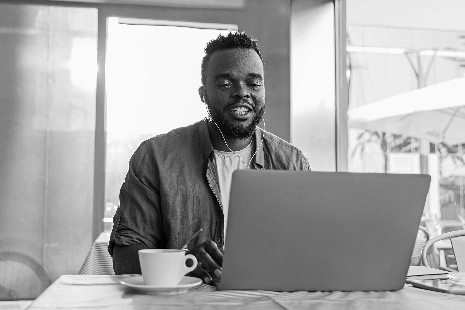 Personal computer, Smile, Photograph, Table, Laptop, Tableware, Human, Black, Black-and-white