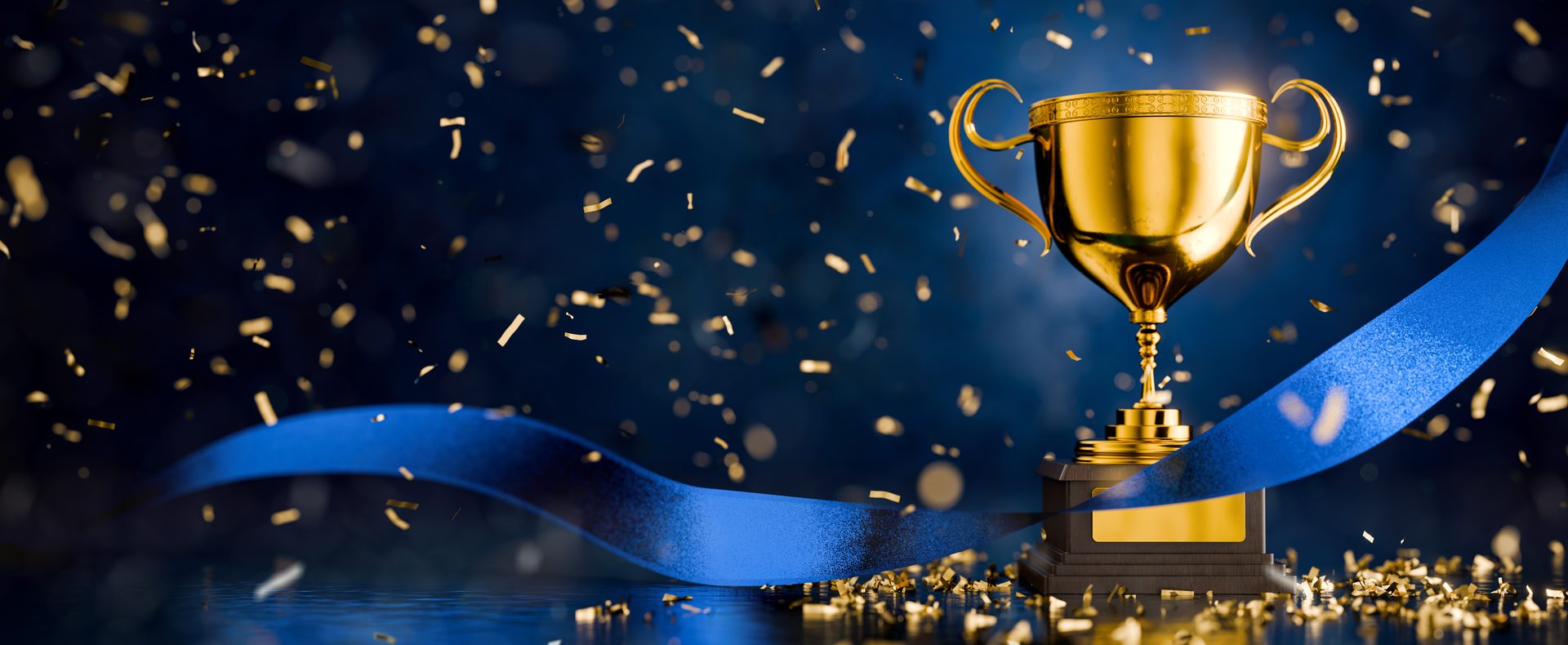 Gold trophy, blue ribbon, and falling confetti against a dark blue background.