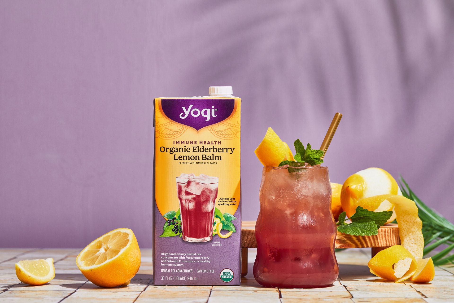 Yogi Organic Elderberry Lemon Balm tea, prepared drink with lemon/mint, fresh lemons and mint.