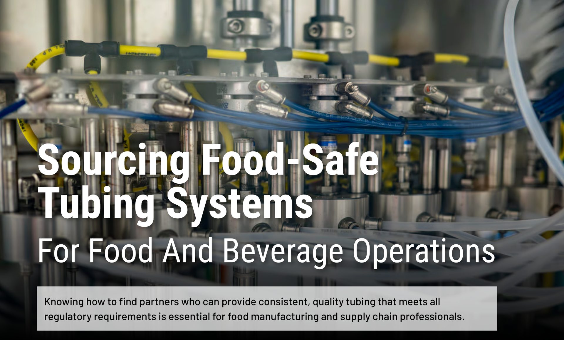 Industrial food processing machinery with intricate yellow and blue tubing for food-safe systems.