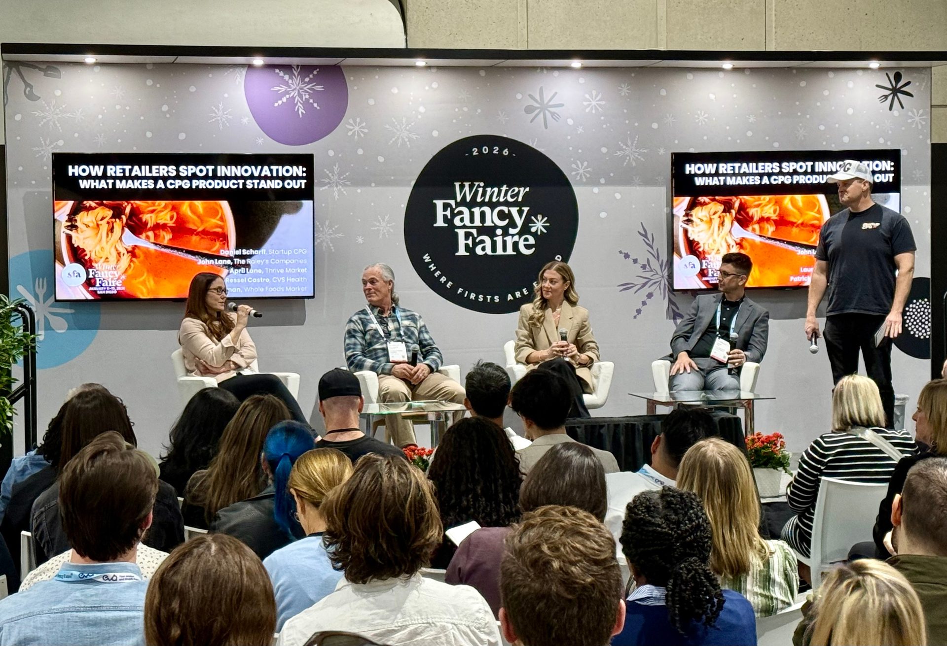 Panelists and a moderator on stage at the Winter Fancy Faire, discussing retail innovation and CPG products.