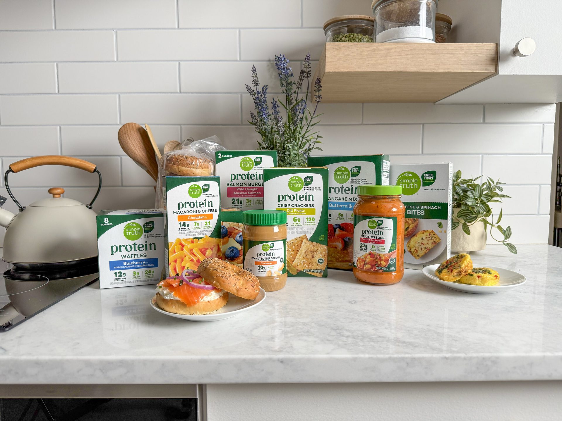 A kitchen counter with a variety of "Simple Truth Protein" brand food products and prepared dishes.