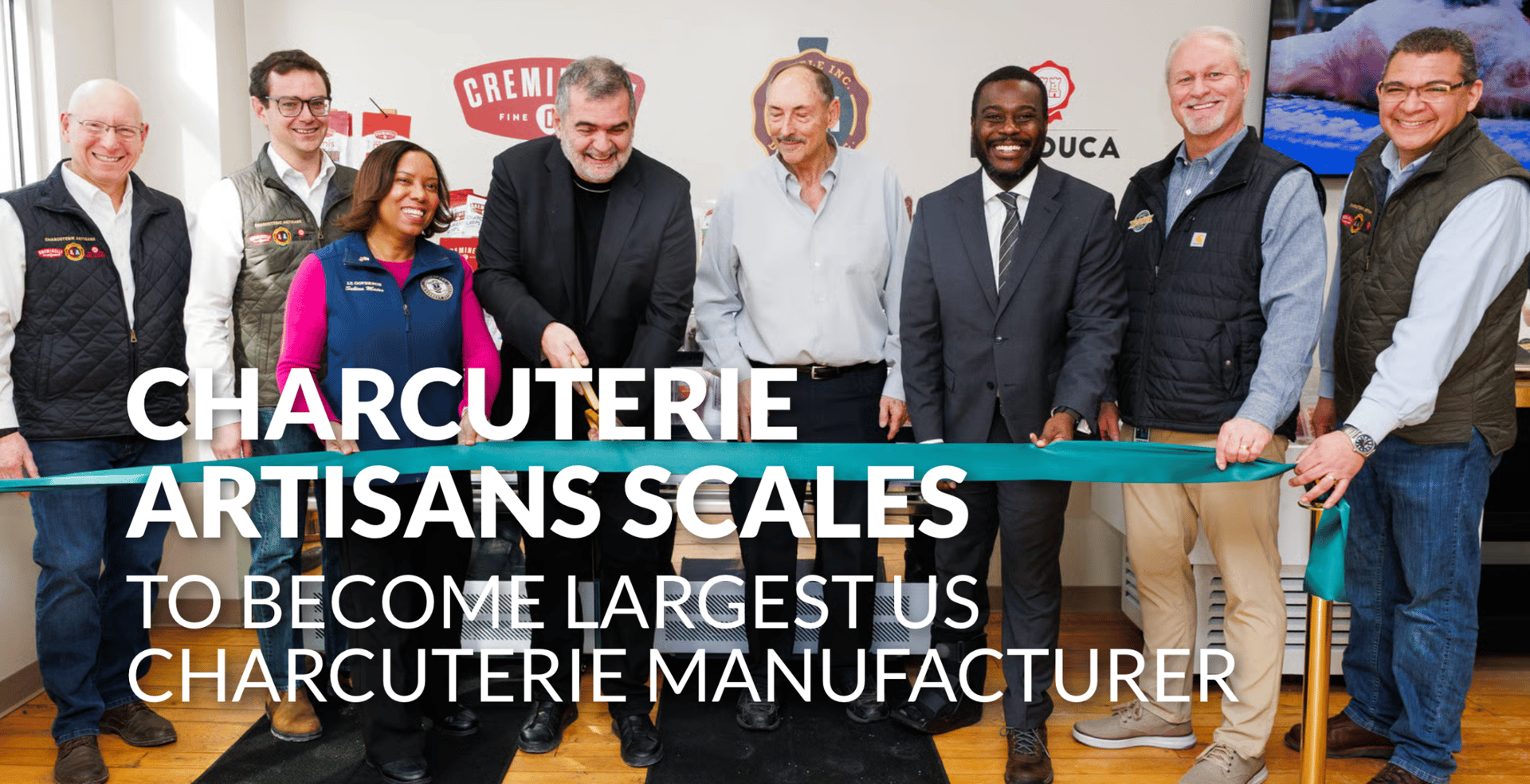 Eight people celebrating a ribbon-cutting ceremony for a charcuterie manufacturer.