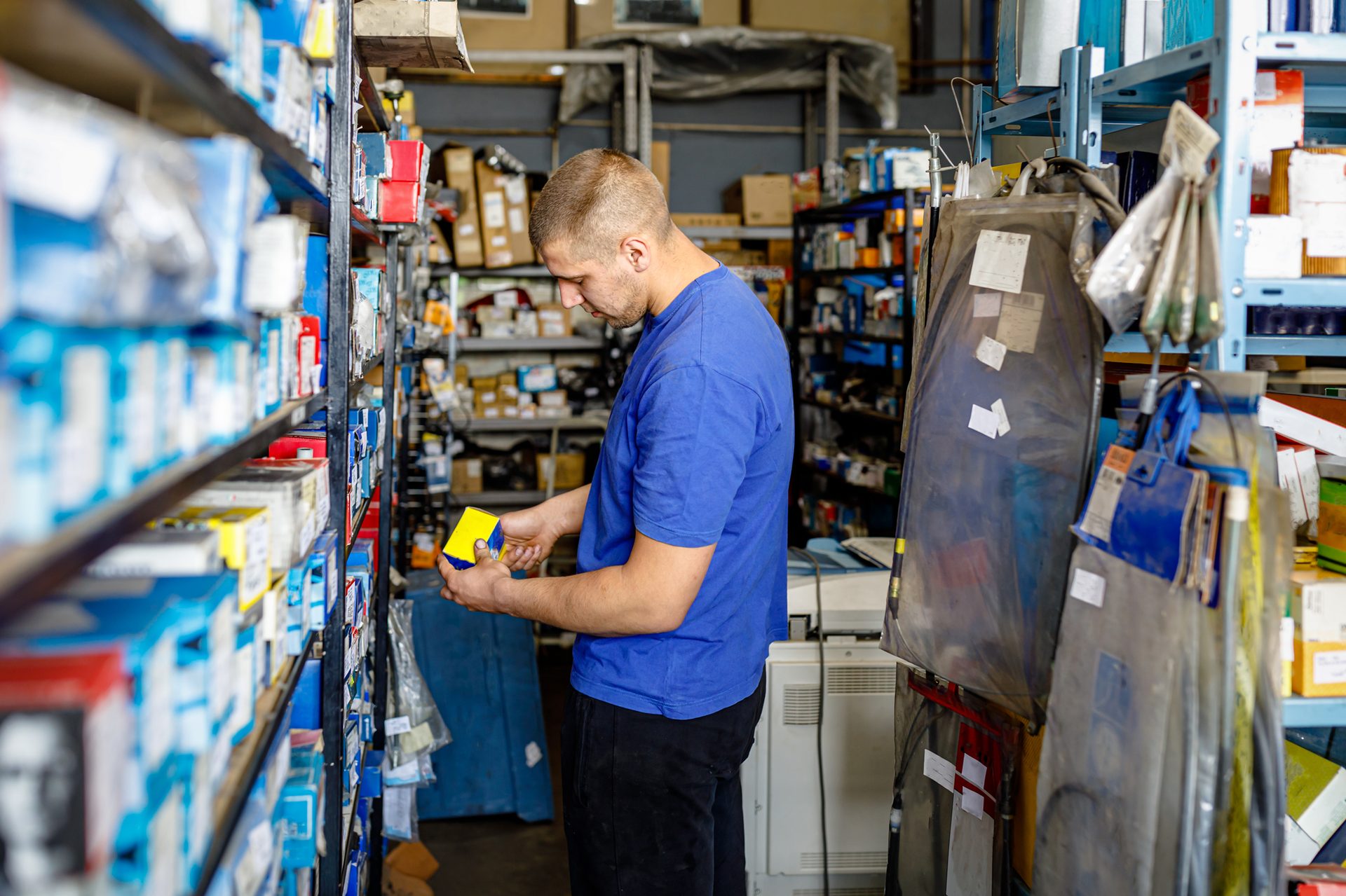 Associate pulling Auto Parts from stock