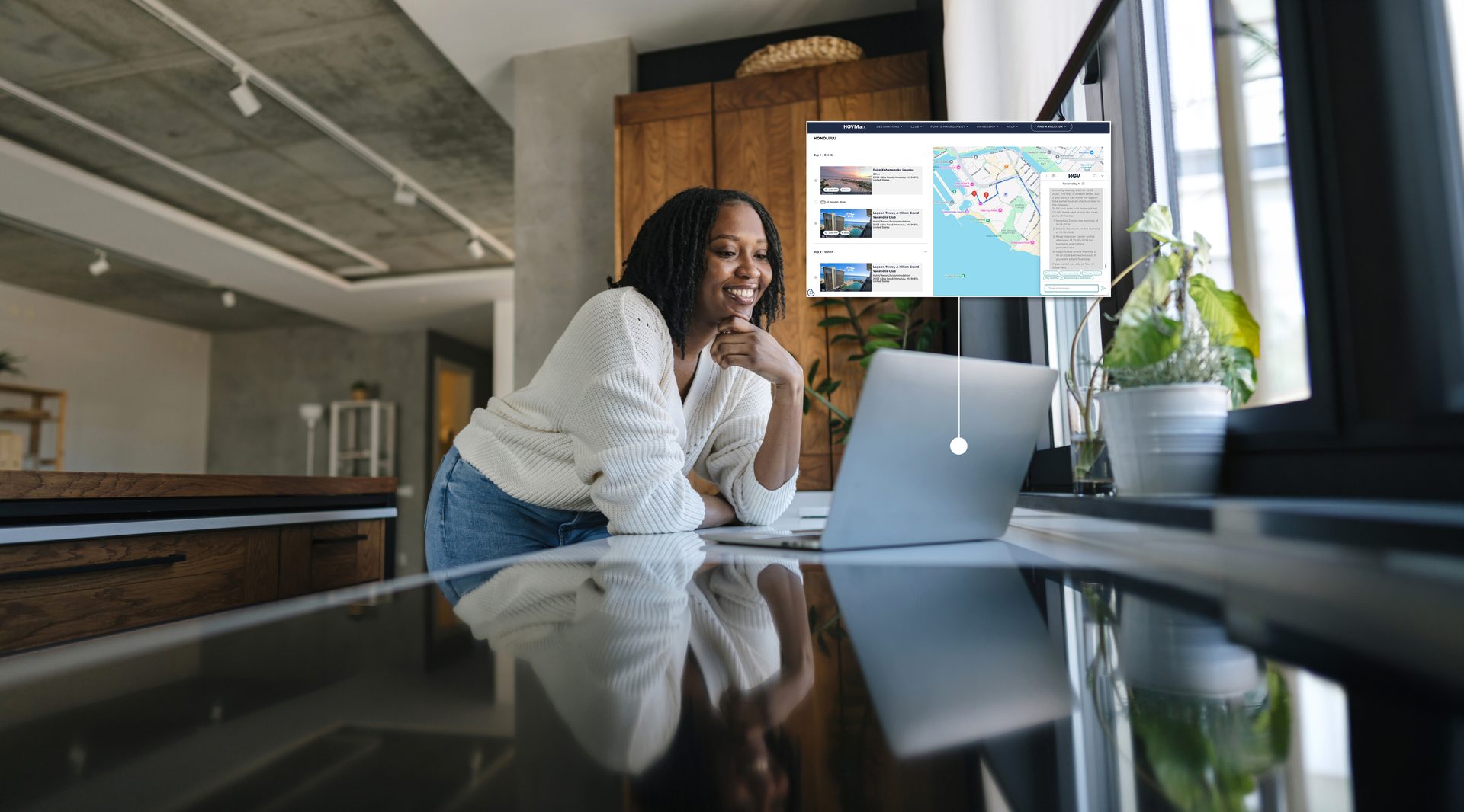 Smiling Black woman uses a laptop in a modern home, browsing real estate listings on screen.