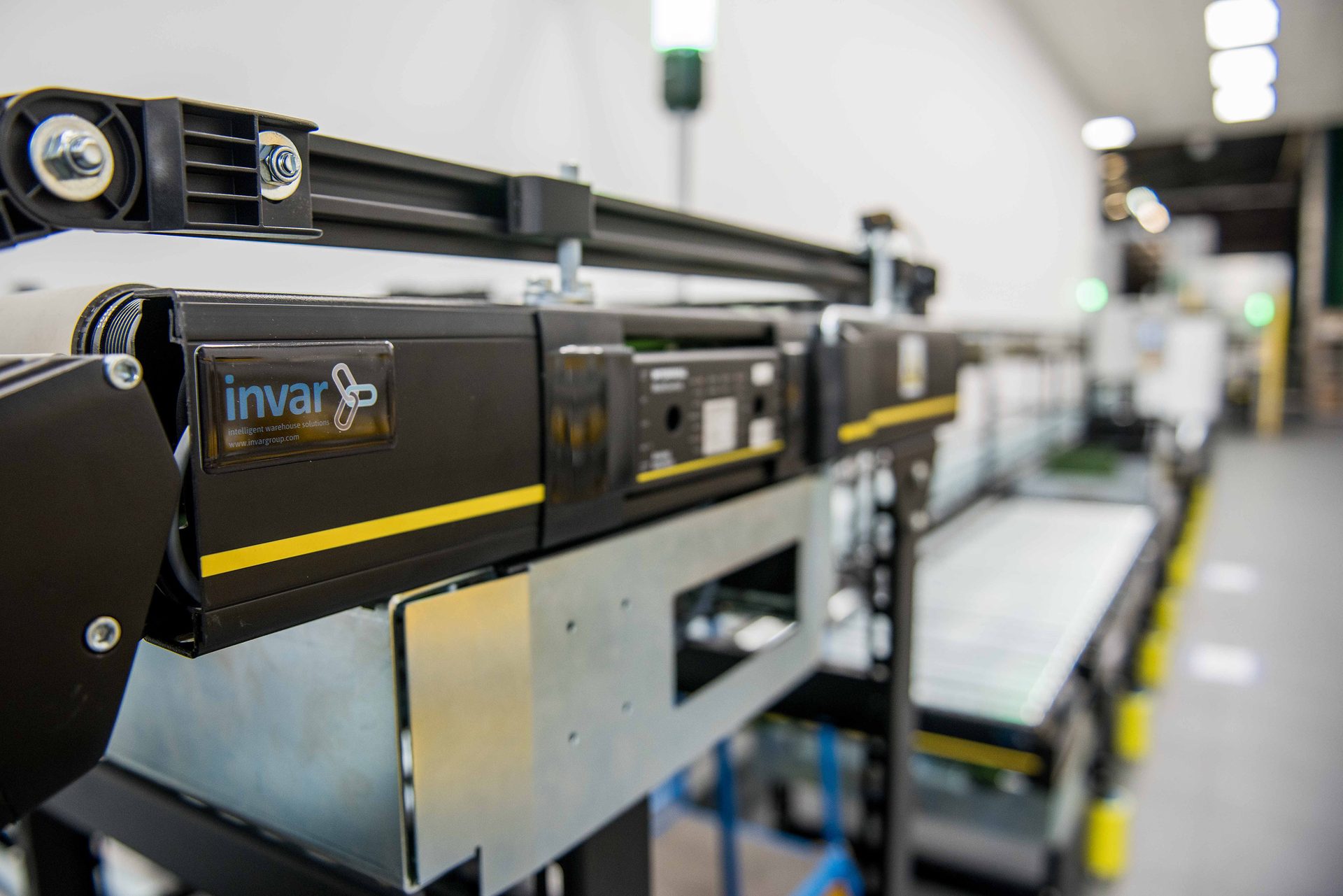 Black & yellow Invar intelligent warehouse conveyor system.