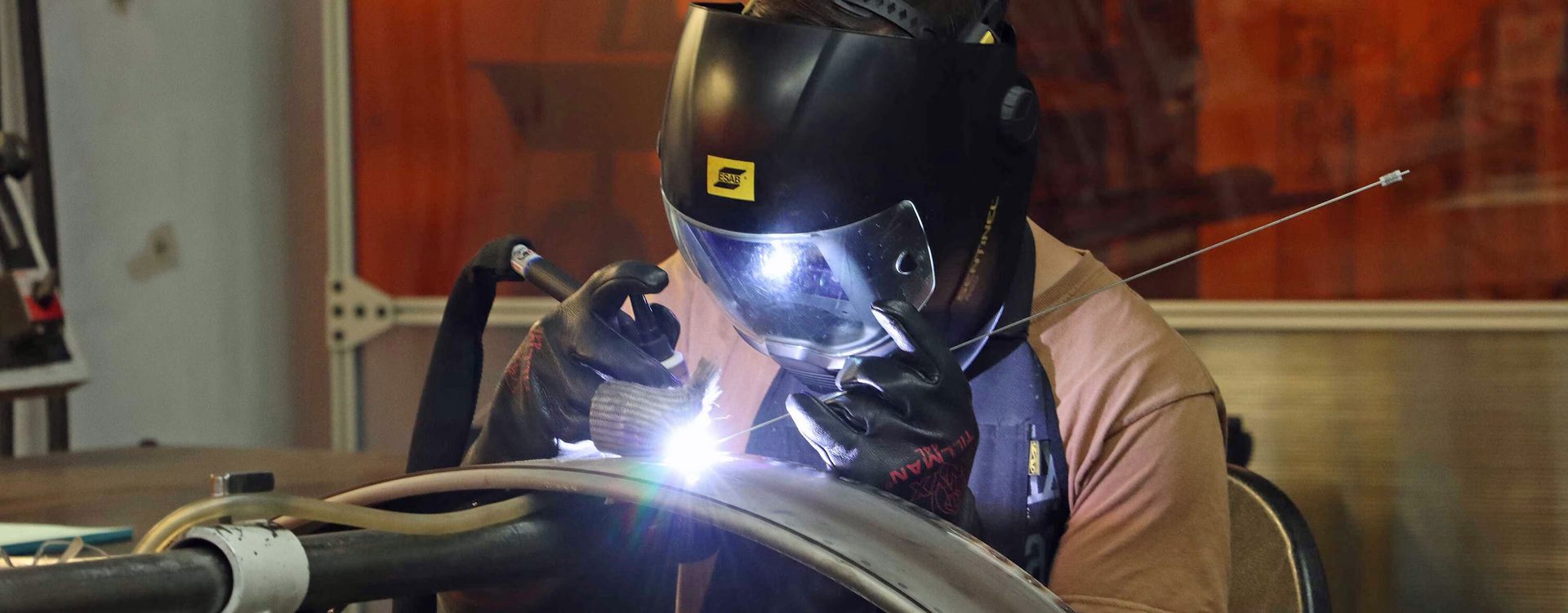 Welding helmet, Automotive tire, Sports gear, Steelworker, Headgear, Workwear