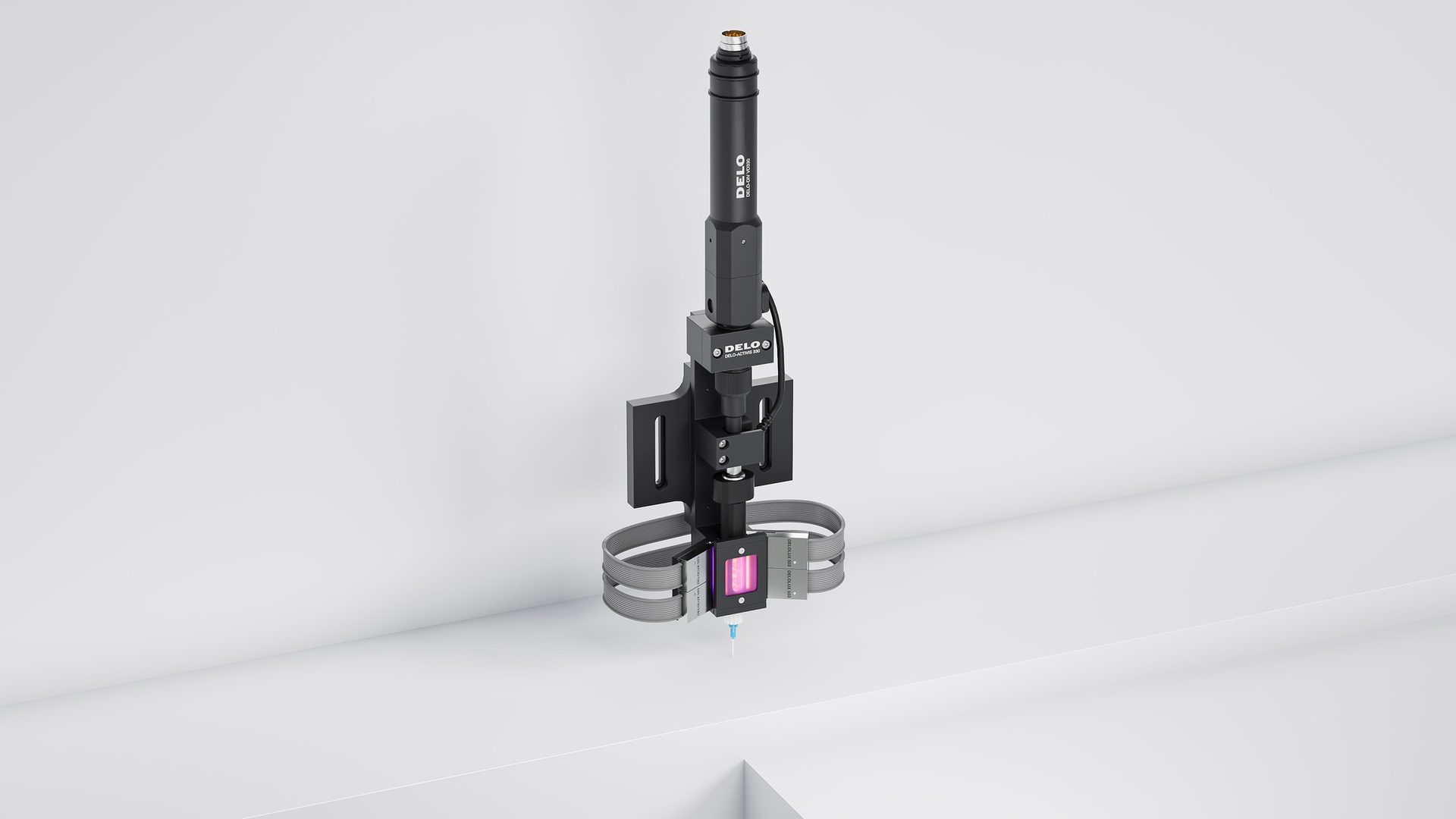 DELO industrial dispenser with nozzle, glowing purple light, and cables against a white background.