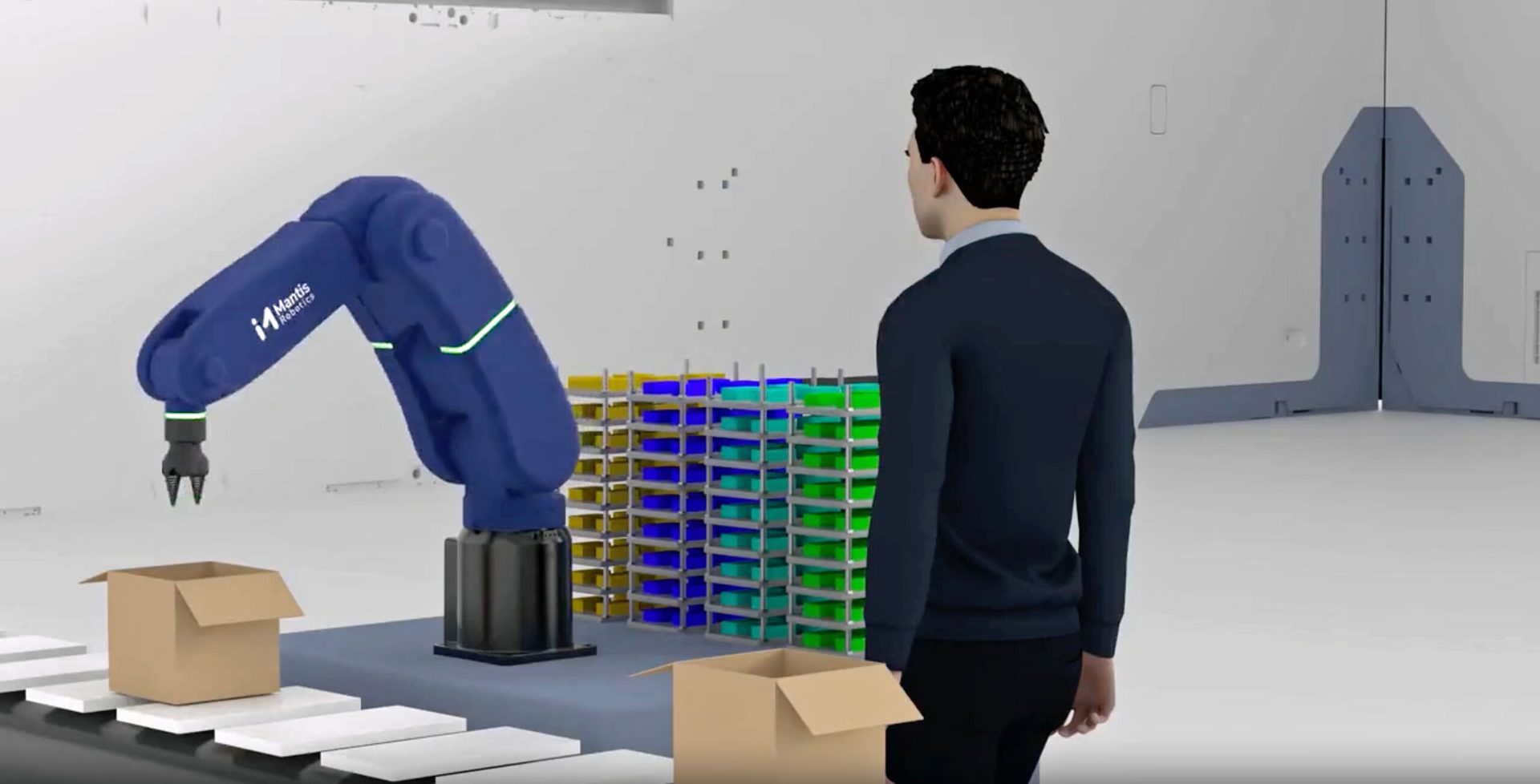 A blue Mantis Robotics arm works on a conveyor belt with boxes, observed by a man in a factory.