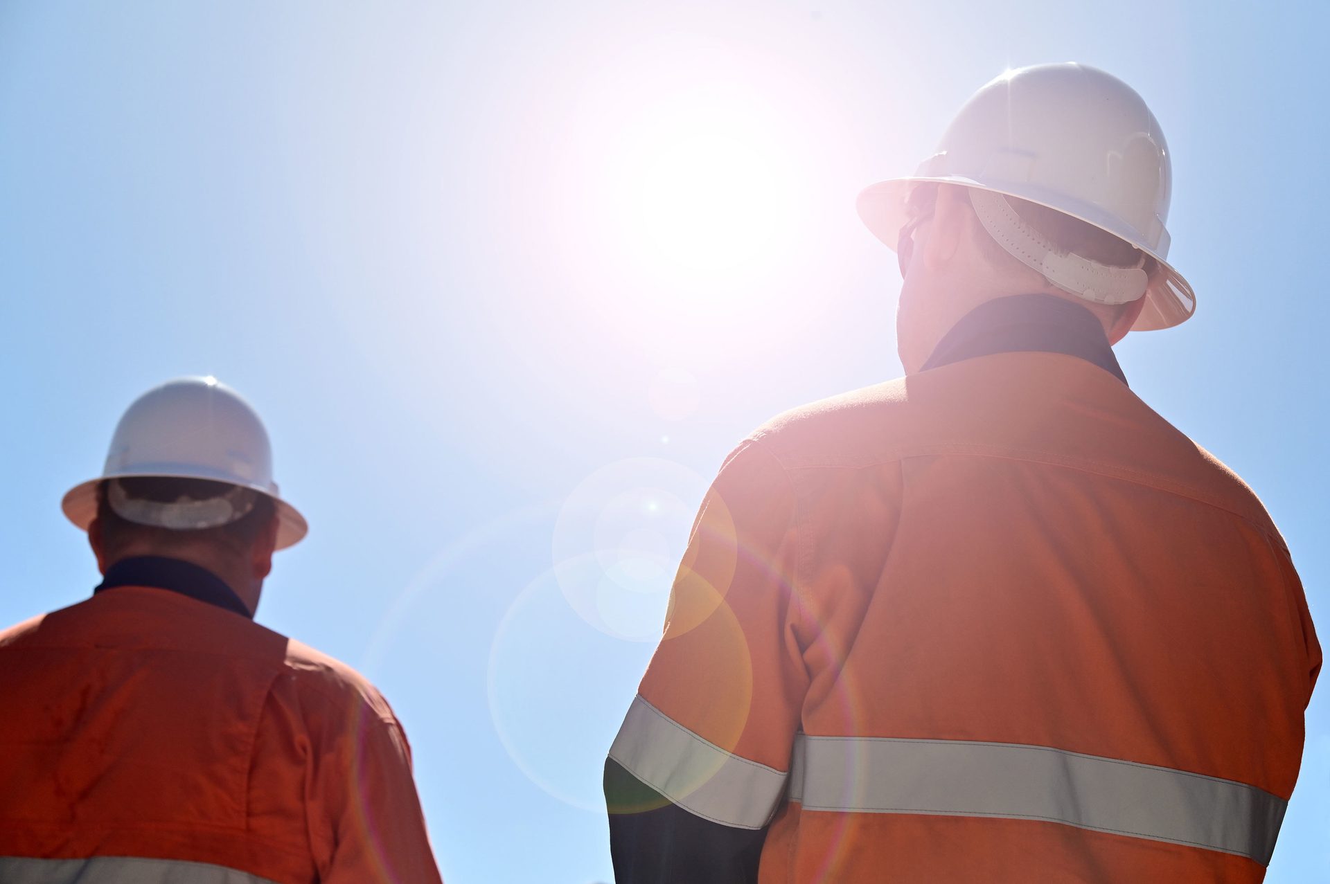 Hard hat, High-visibility clothing, Sky, Workwear, Gesture, Engineer, Headgear
