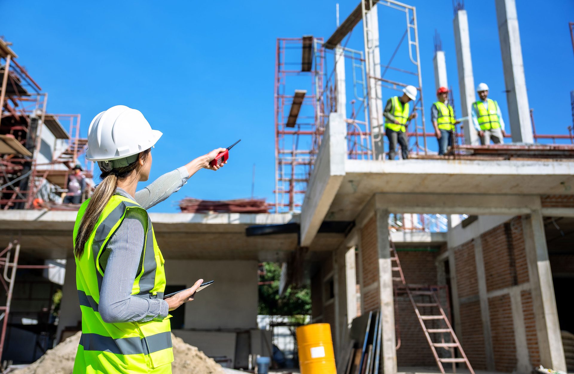 Hard hat, High-visibility clothing, Construction worker, Composite material, Sky, Workwear, Tradesman, Helmet, Engineer, Yellow
