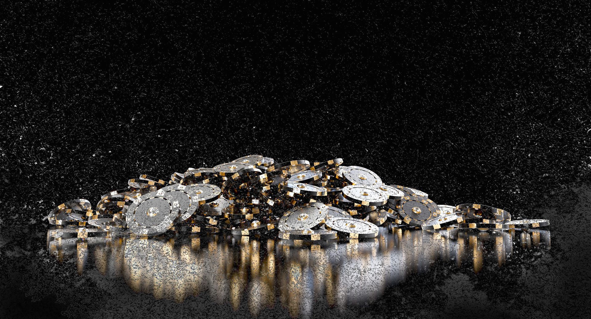 Pile of gold and silver casino chips reflecting on a dark surface, black background.