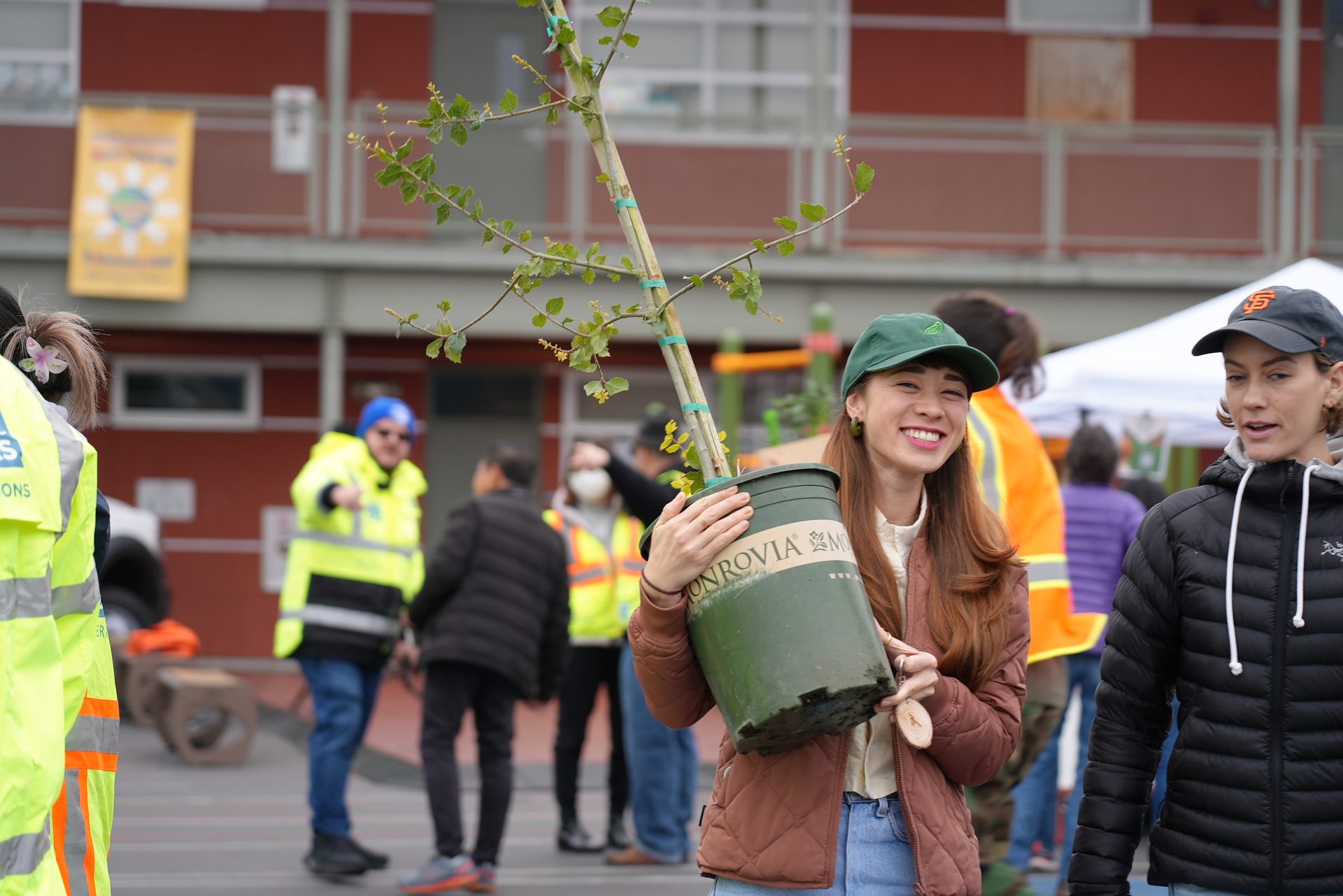 High-visibility clothing, Jeans, Outerwear, Green, Smile, Building, Yellow, Headgear, Jacket, Workwear