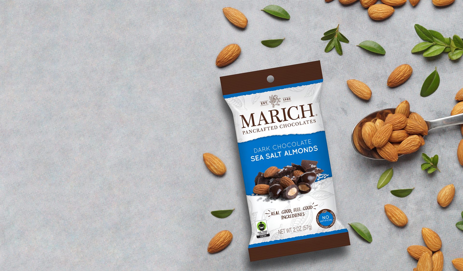 Marich Dark Chocolate Sea Salt Almonds package surrounded by almonds and leaves