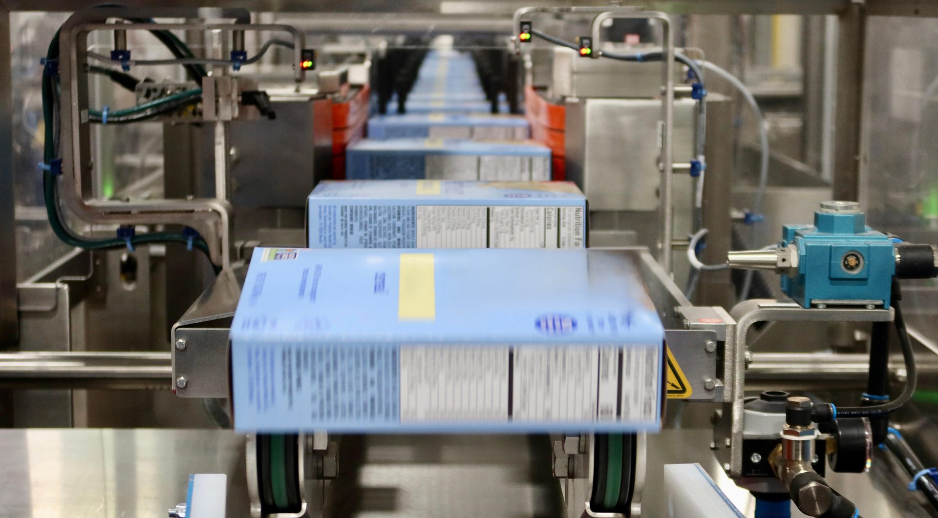 Several bags-in-boxes move down the conveyor of the Alterion CL-170 cartoner at the GreenSeed plant