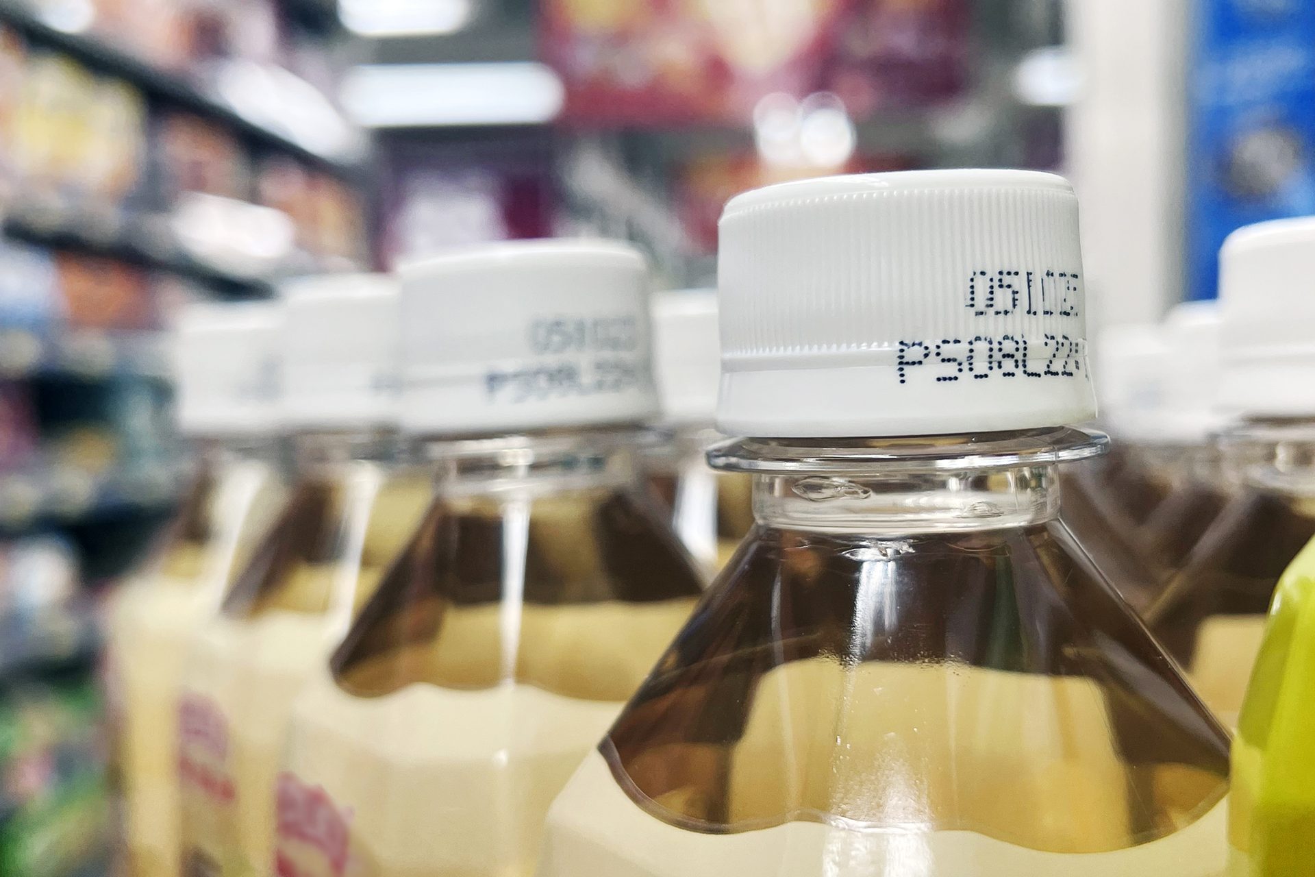 Drinks with expiry date printed on caps in supermarket