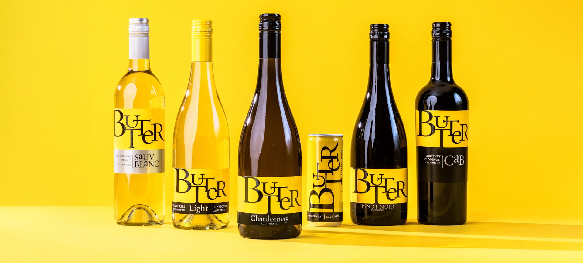 Bottles of Butter Wines products against yellow background