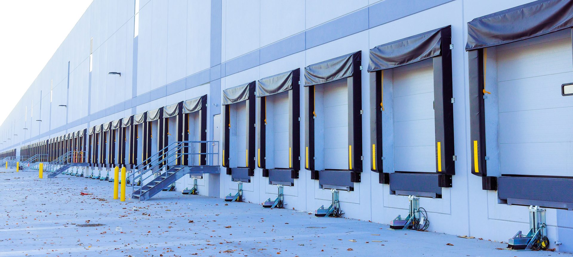 Sectional gates for transferring goods from truck on a distributed warehouse