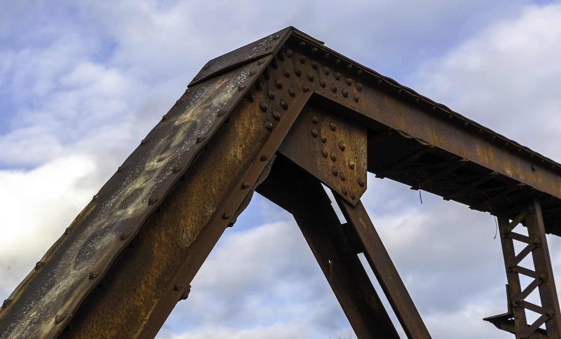 The upper corner of the rusty old bridge