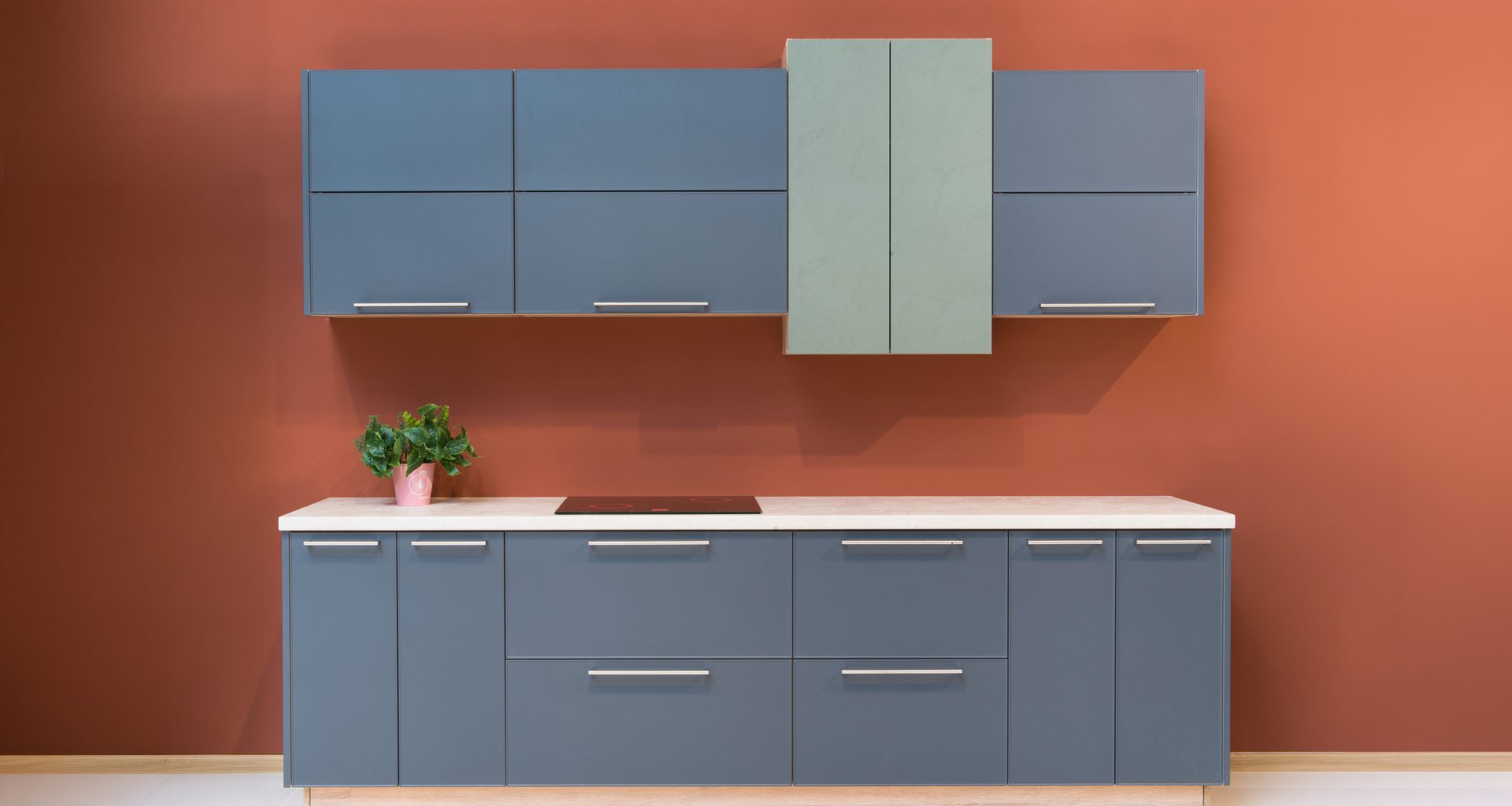 Modern kitchen room interior with brown rust colored walls and furniture and slate colored cabinets