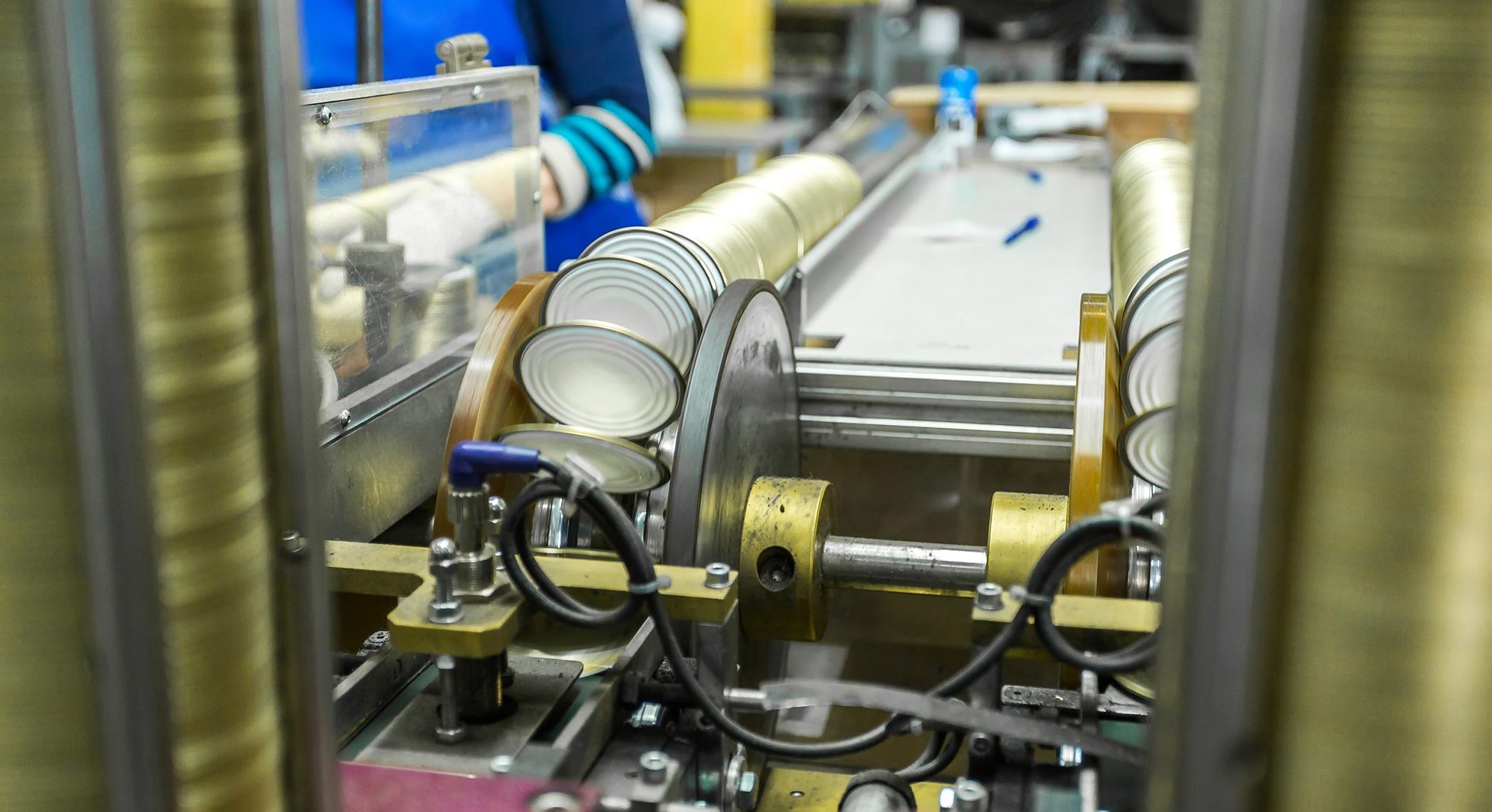 Image of beverage cans being assembled in a packaging facility