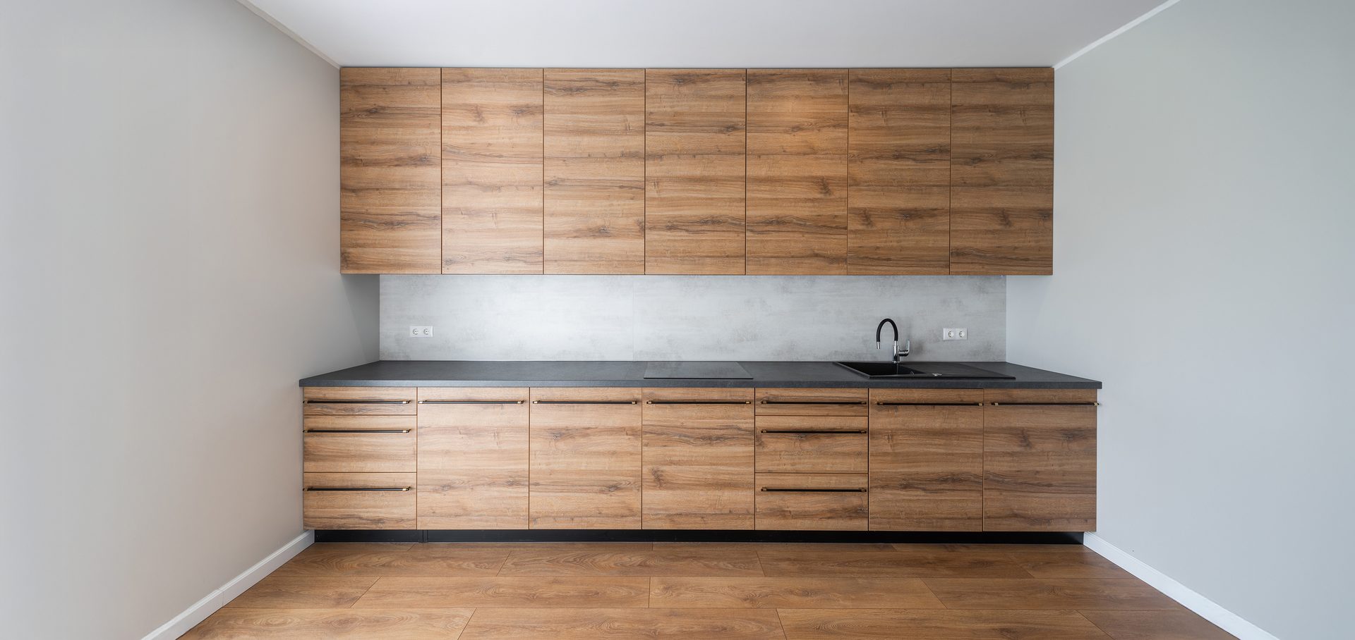 nterior of modern kitchen with wooden floors and cabinets