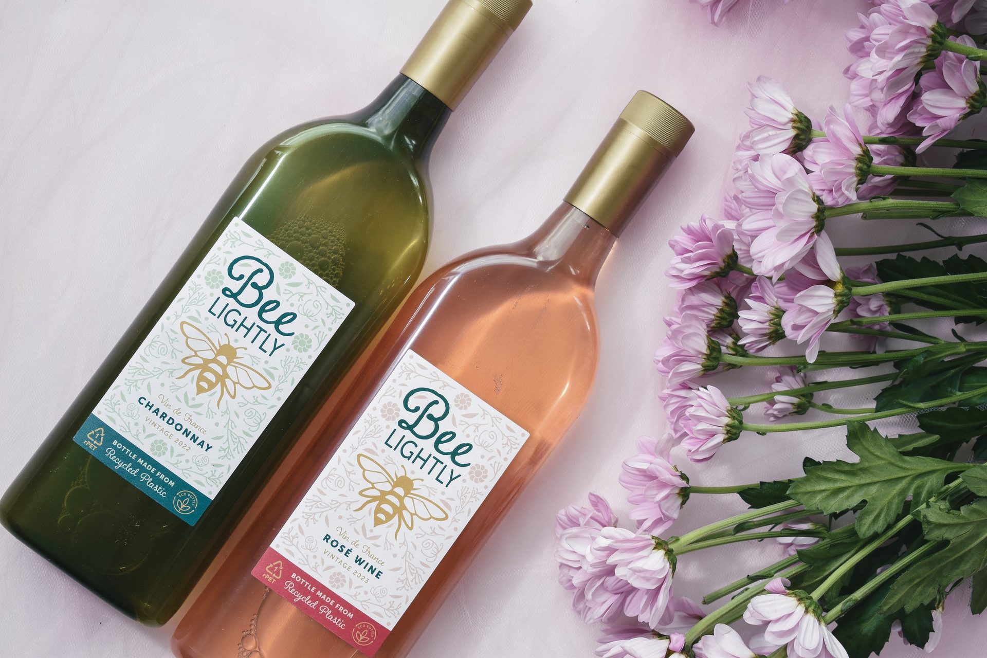 Image of two bottles of Bee Lightly wine featuring Packamama’s signature flat bottle design.