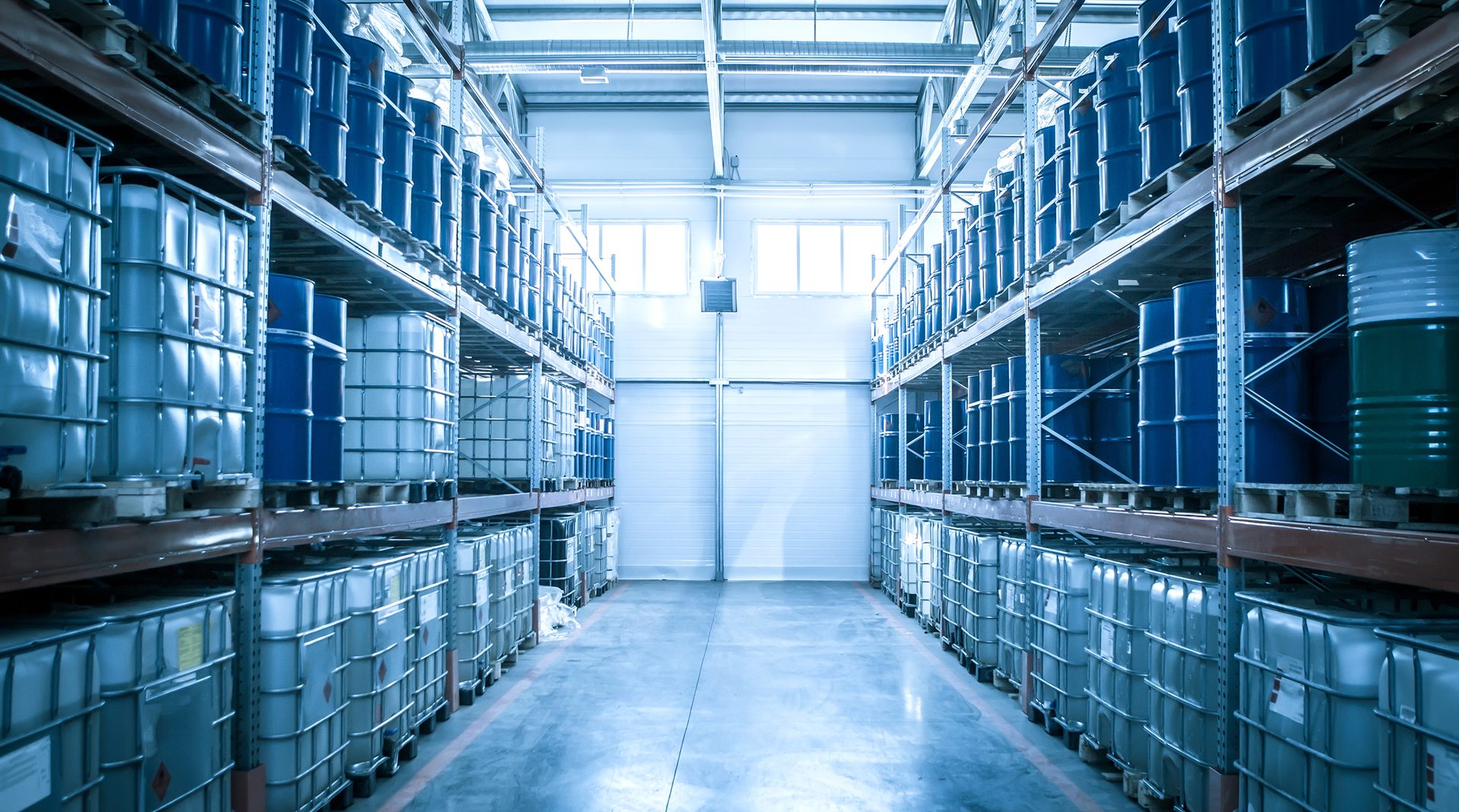 Chemical warehouse. Barrels with chemical products. Shelvings with barrels. Warehouse shelving.
