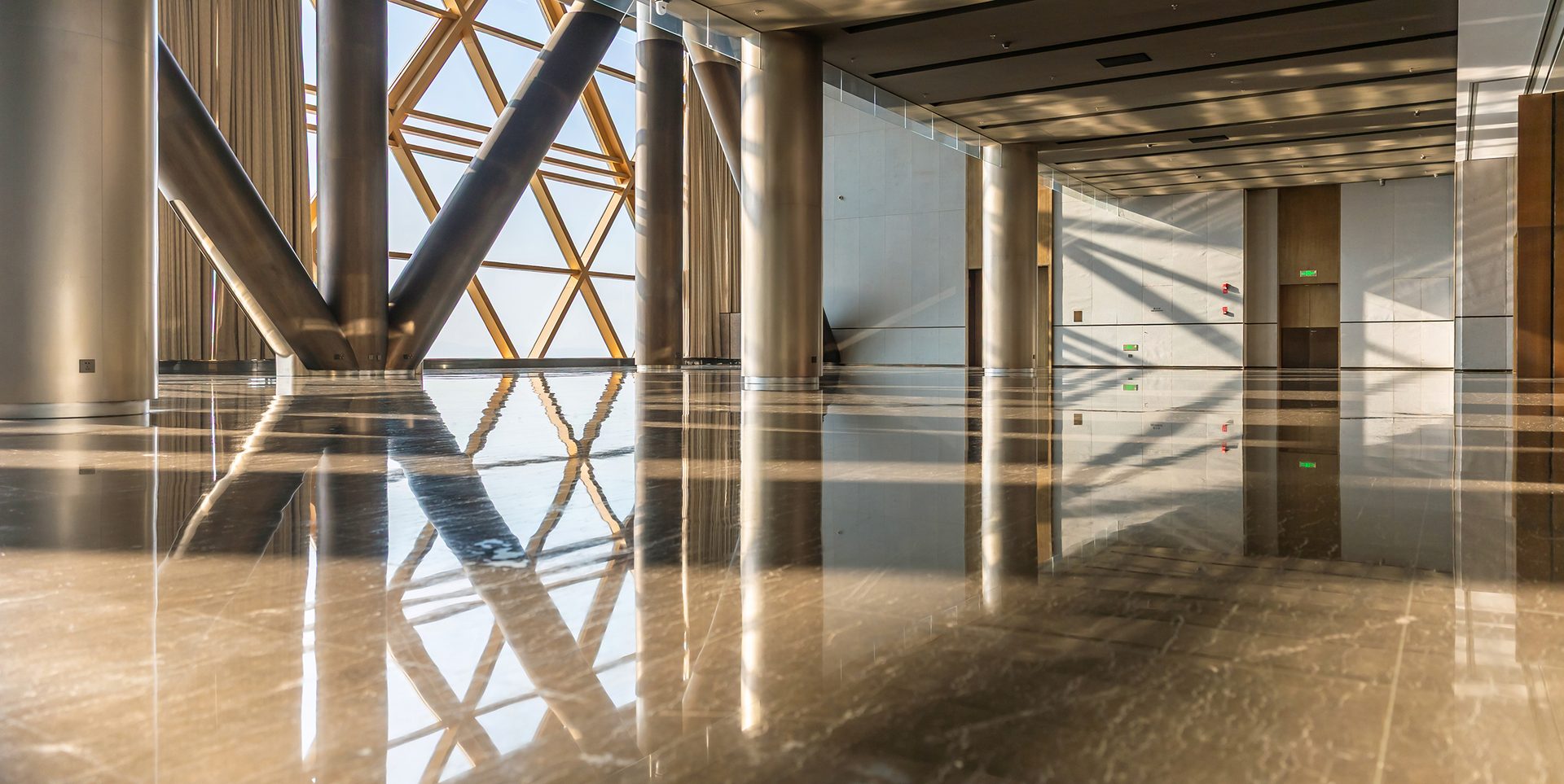 Sunlight streamed into the hall with shiny flooring